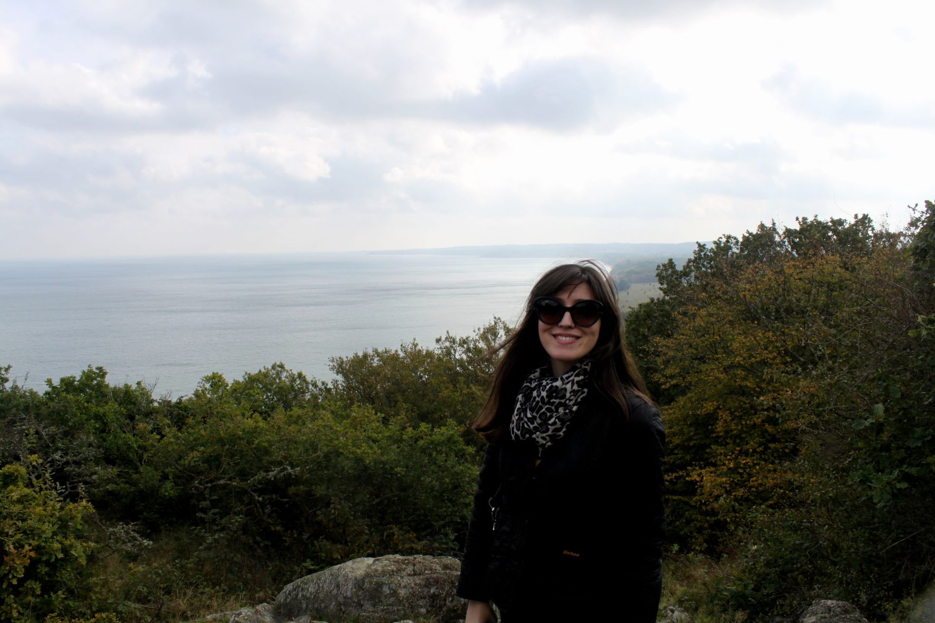 Dena, a student in Sweden from Montenegro, posing on top of a hill.