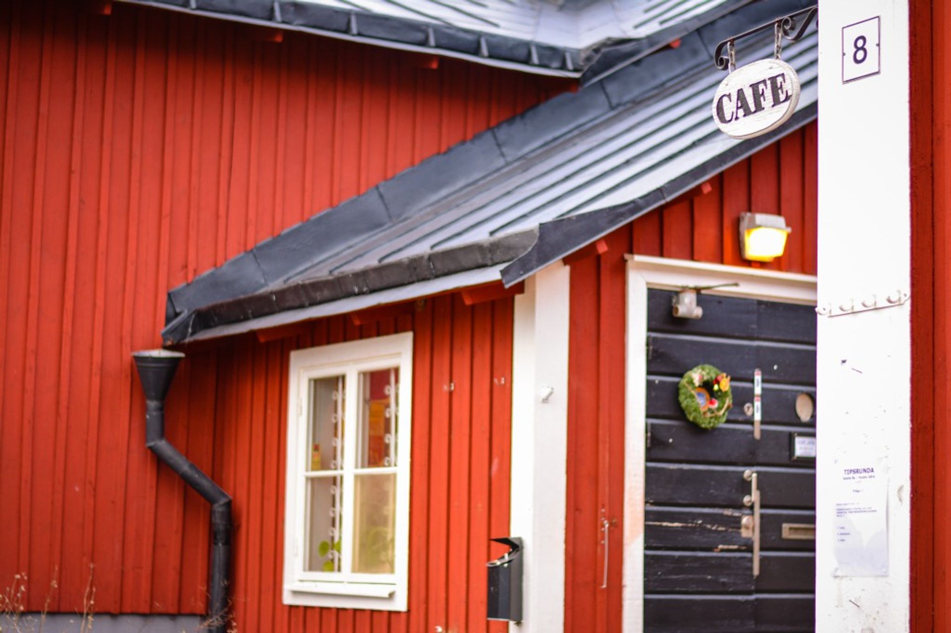 Charming red siding? Check. Little cafe sign? Check.