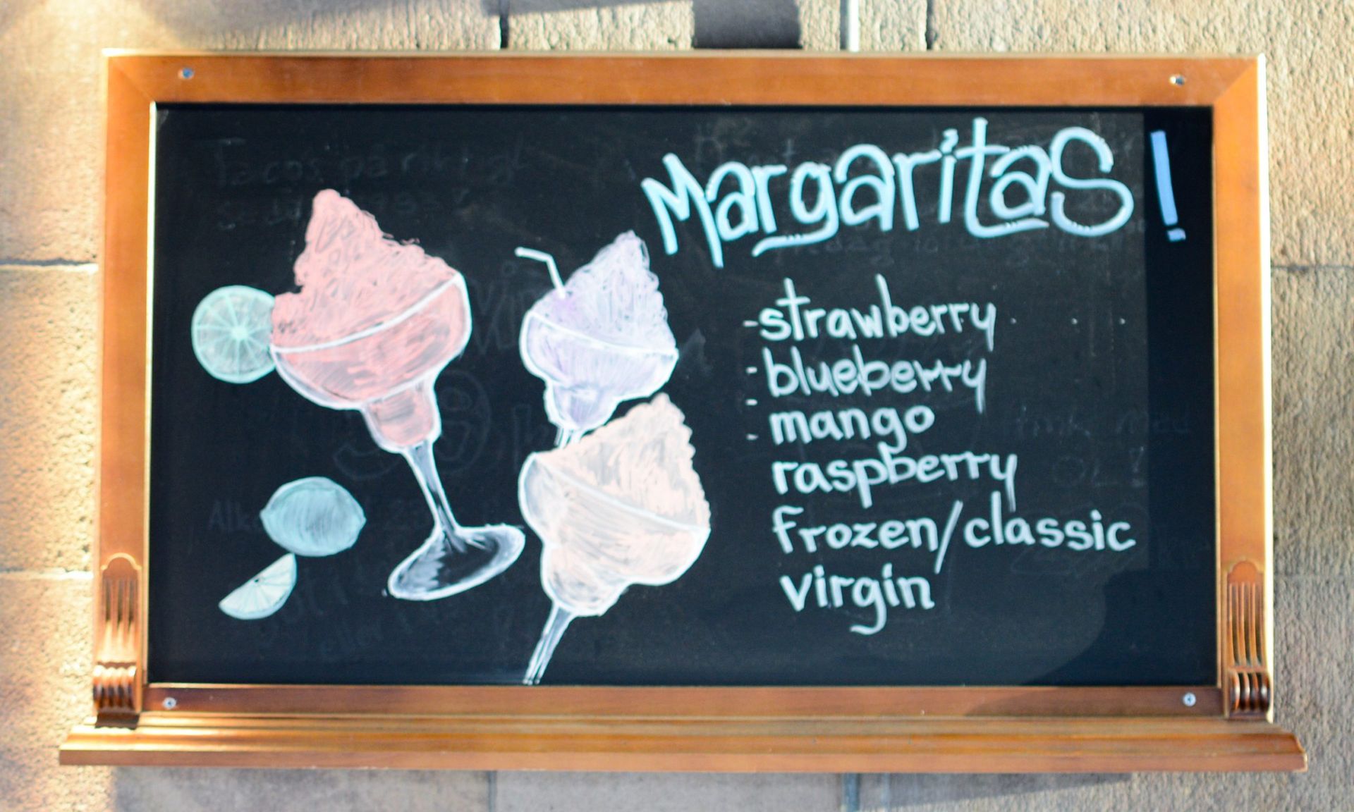 Chalkboard with margarita cocktails drawn on it.