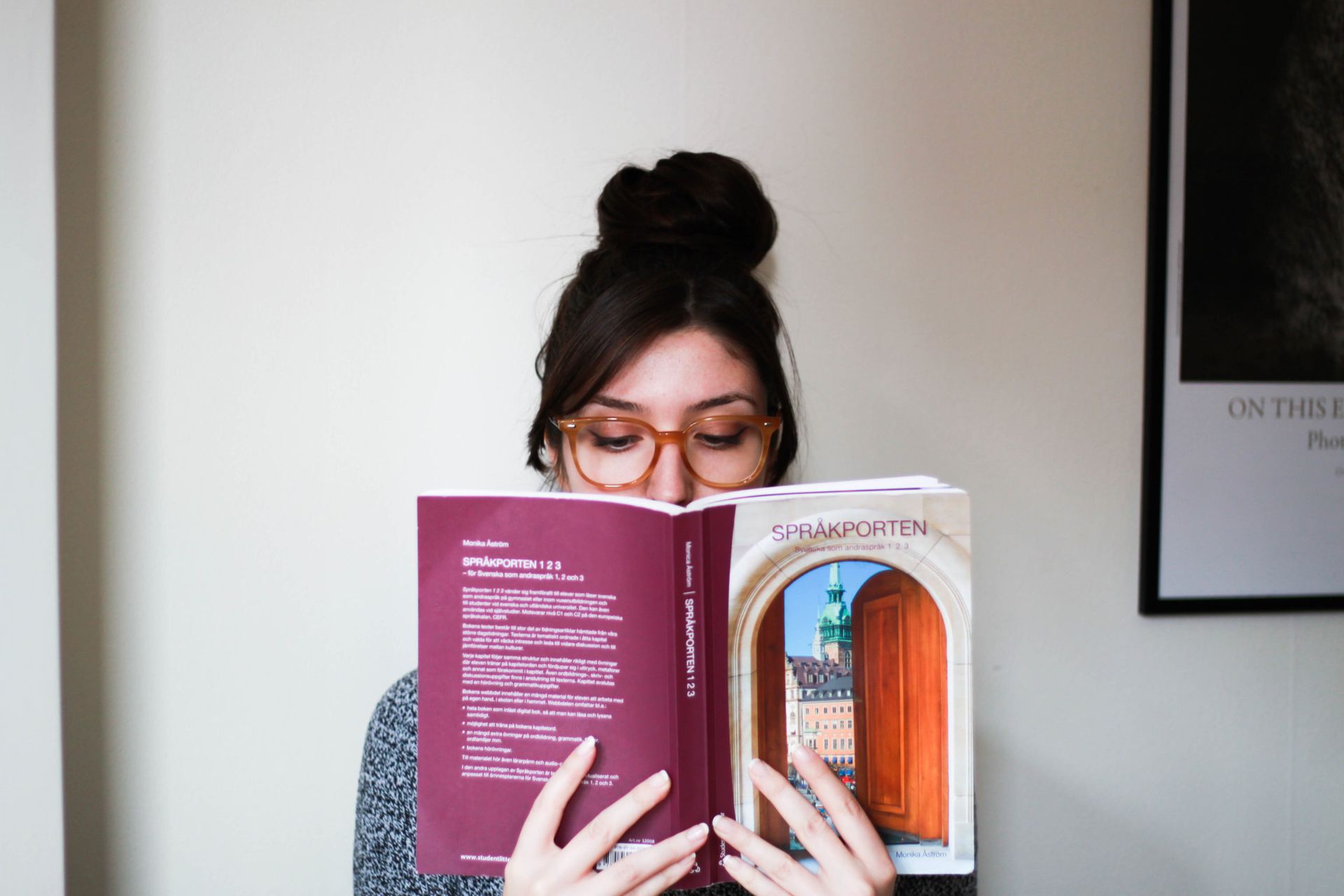 A person reading a Swedish language textbook.