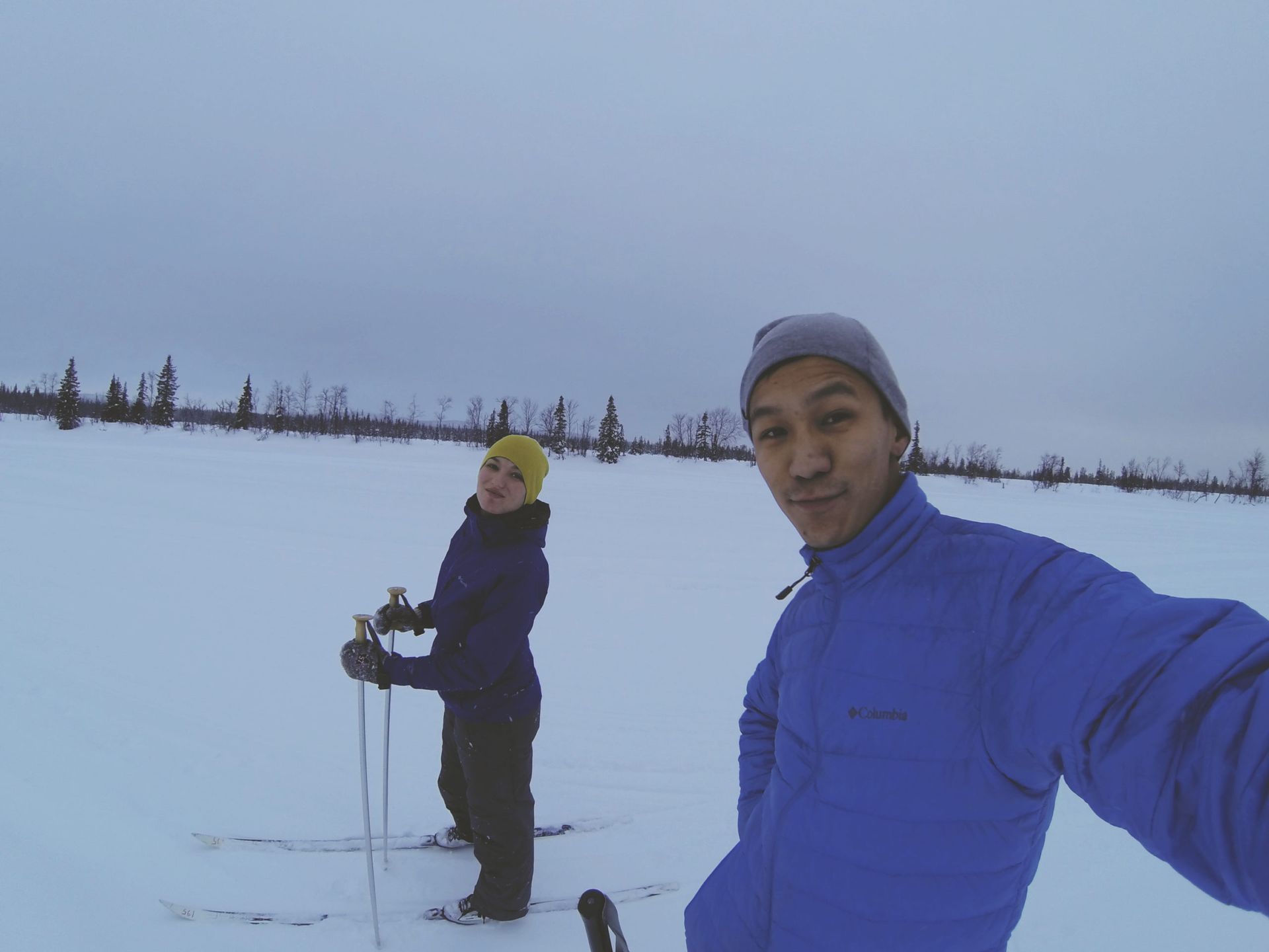 A photo of two international students doing cross-country skiing.