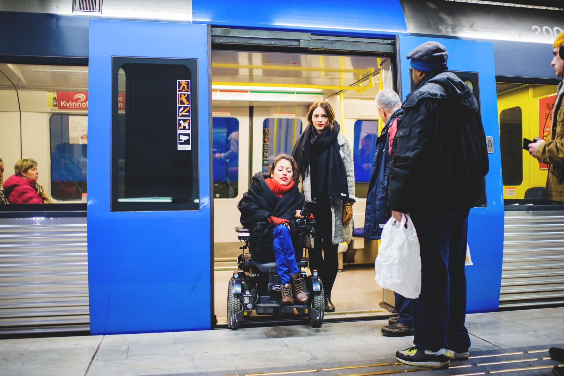 Person in a wheelchair exiting a train.