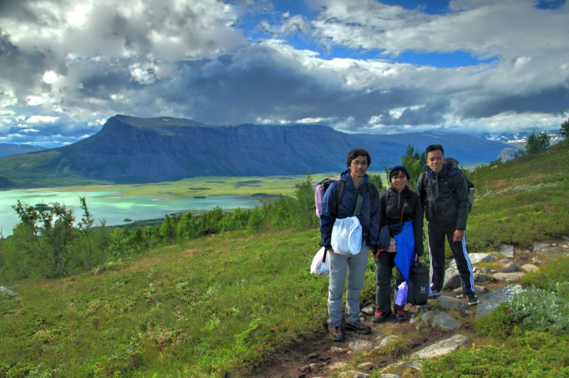 Hikers posing for a photo on a trail.