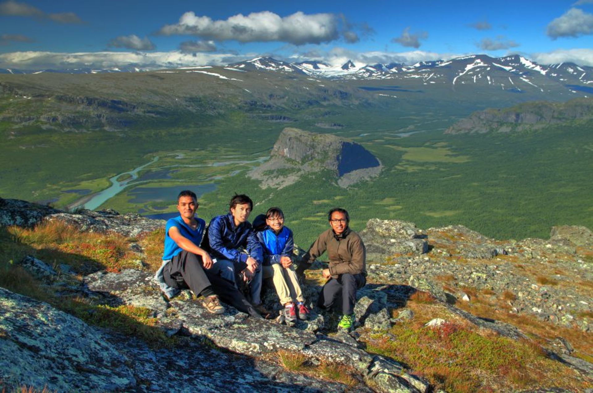 Hikers posing for a photo on a mountainside.