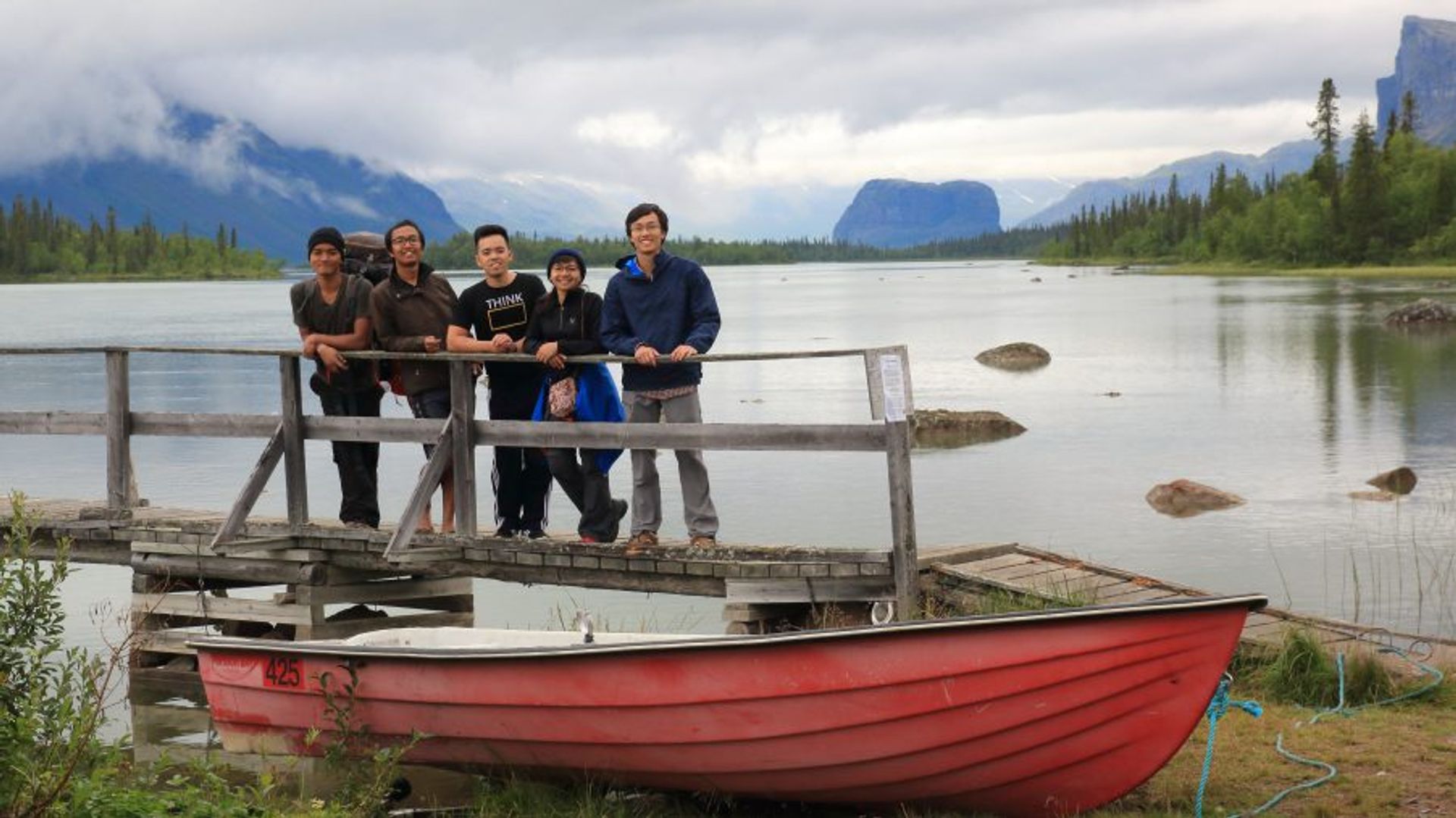 Hikers posing in front of a river.