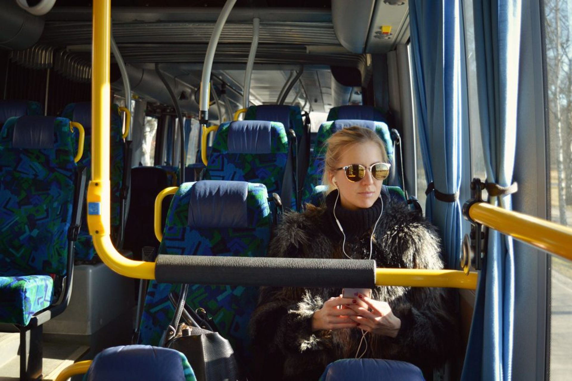 A passenger listening to music on the bus