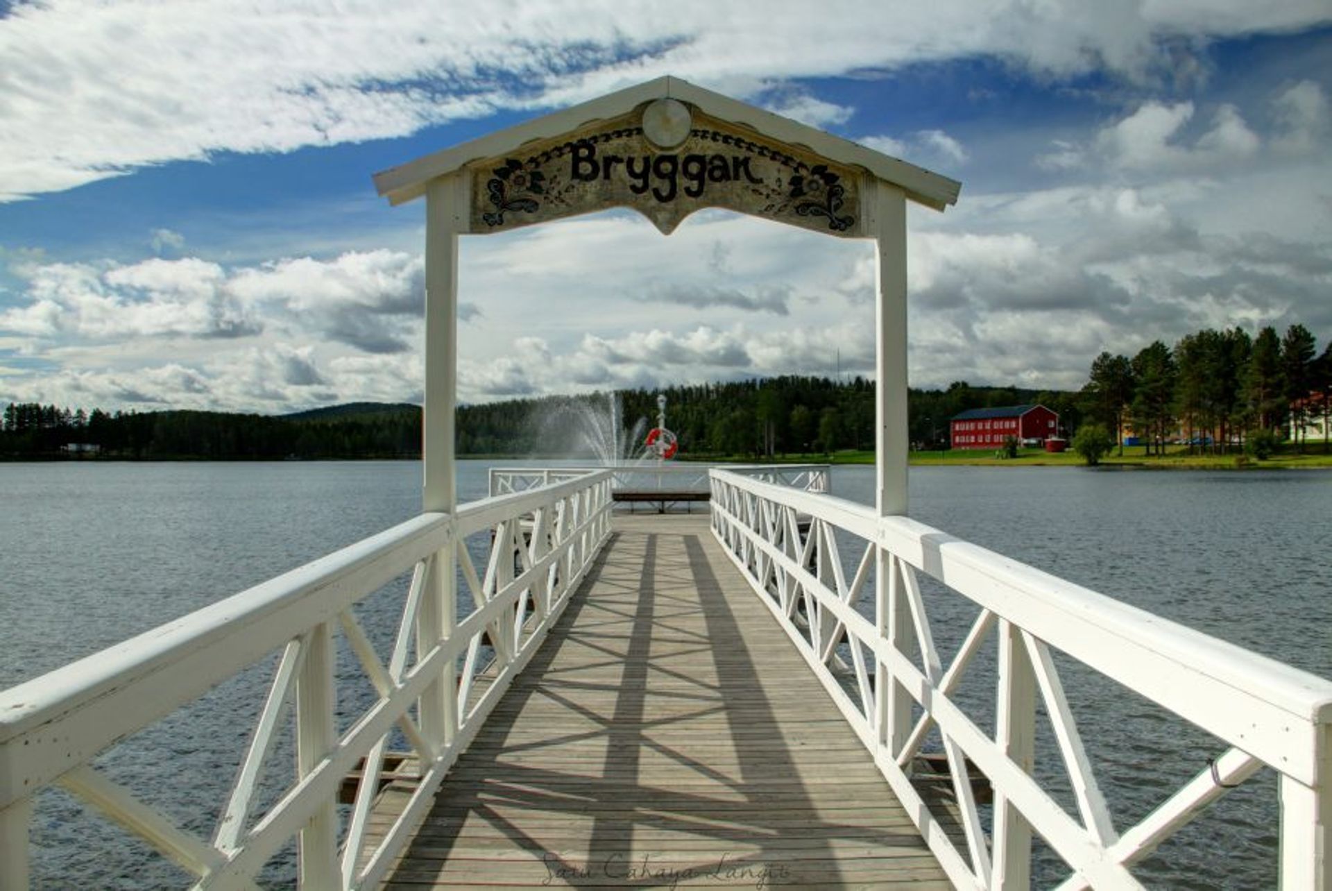 A white jetty on a lake.