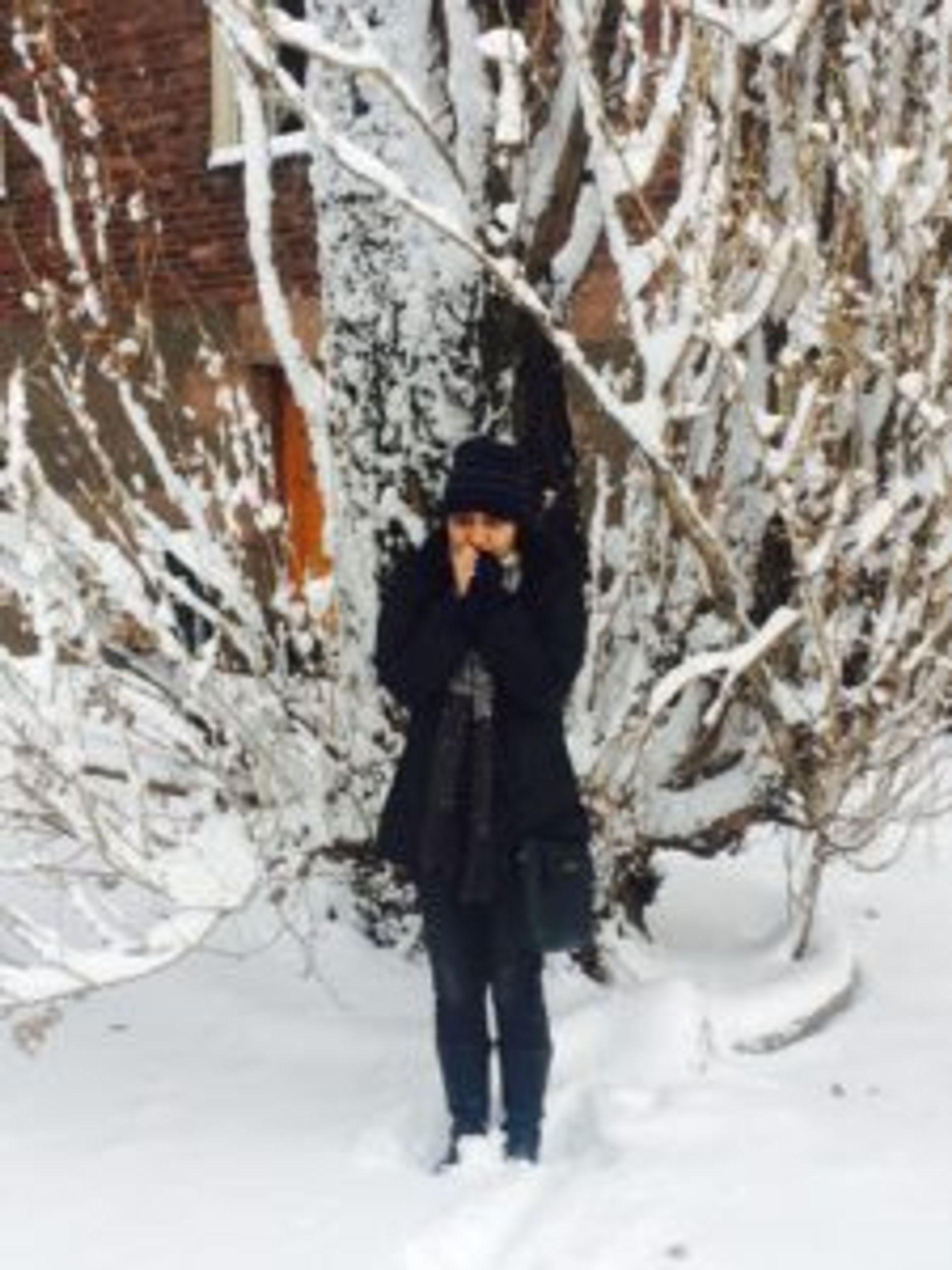 A student standing in the snow.