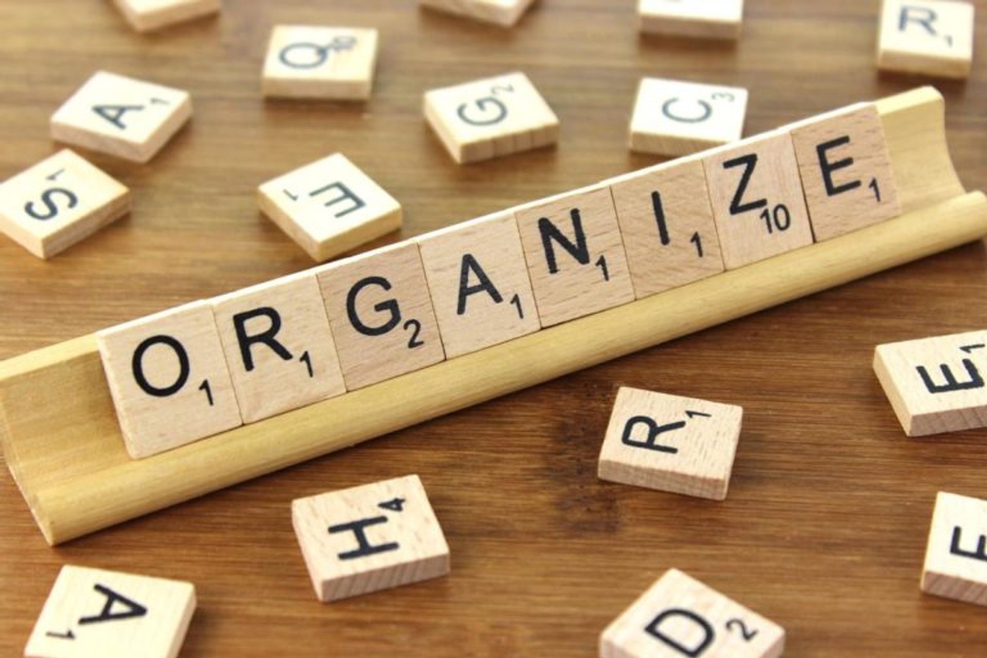 Scrabble letters spelling out 'Organize'.