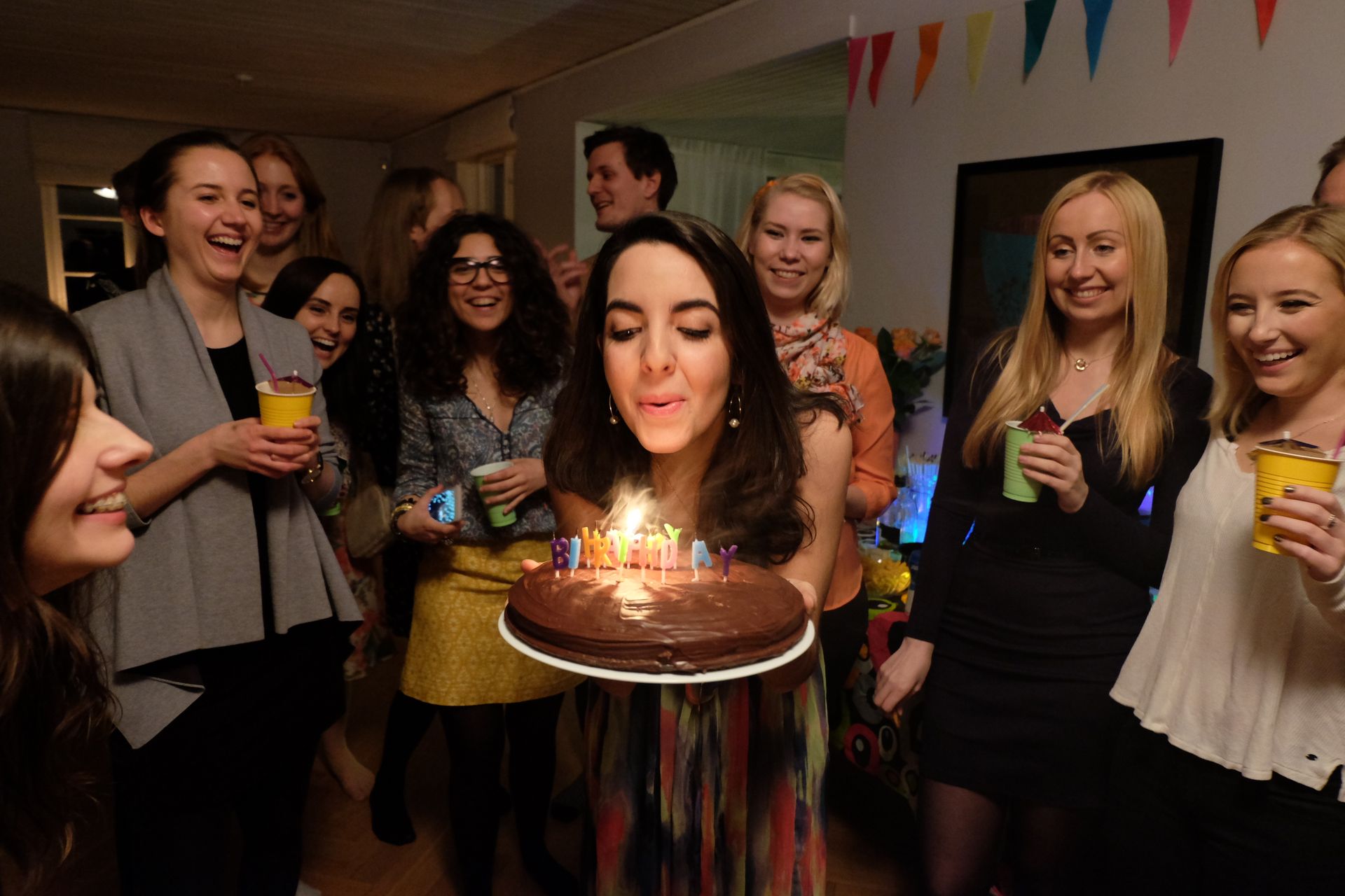 Person blowing out candles on a birthday cake.