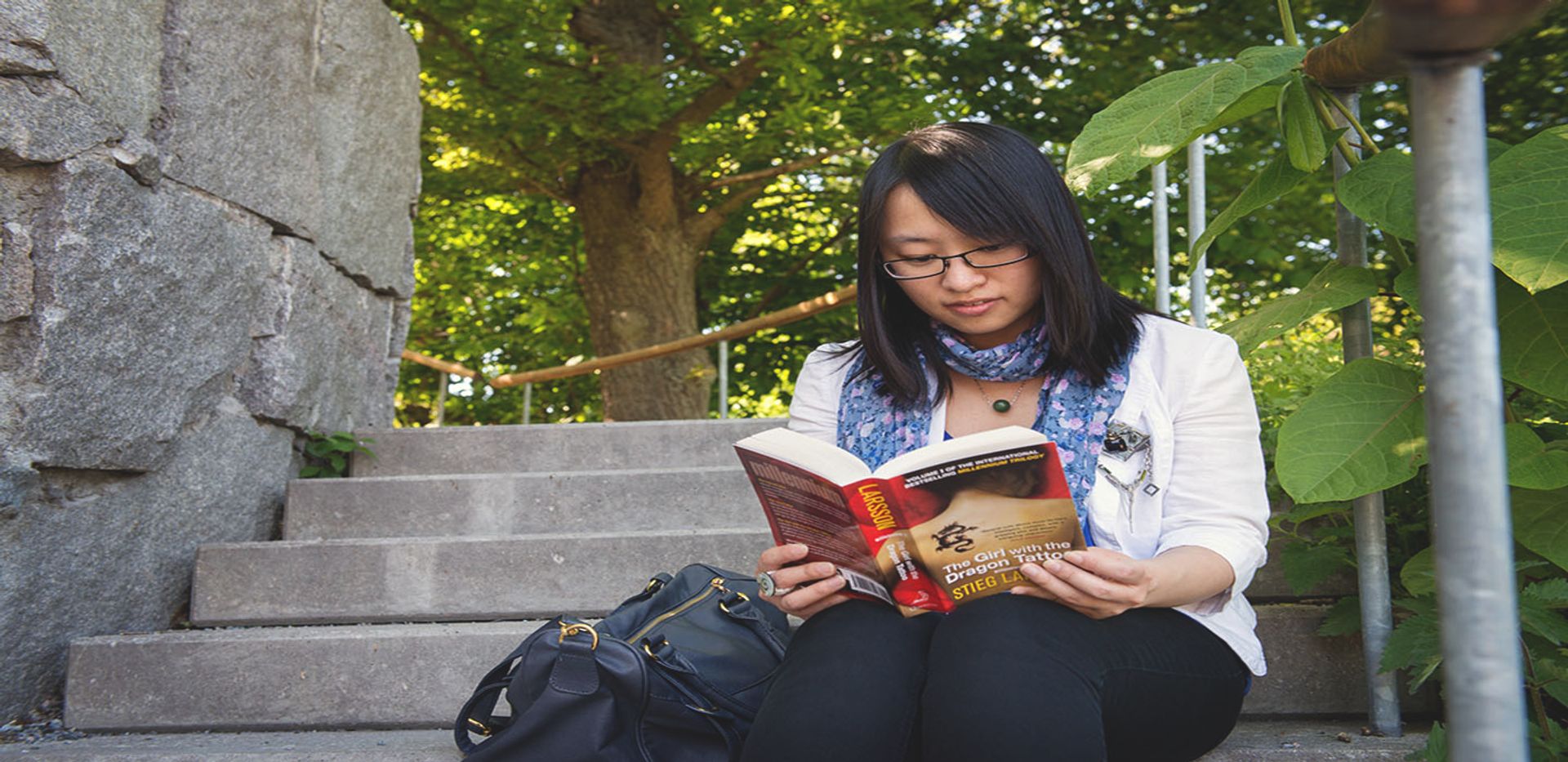 girl reading girl with the dragon tattoo in stockholm