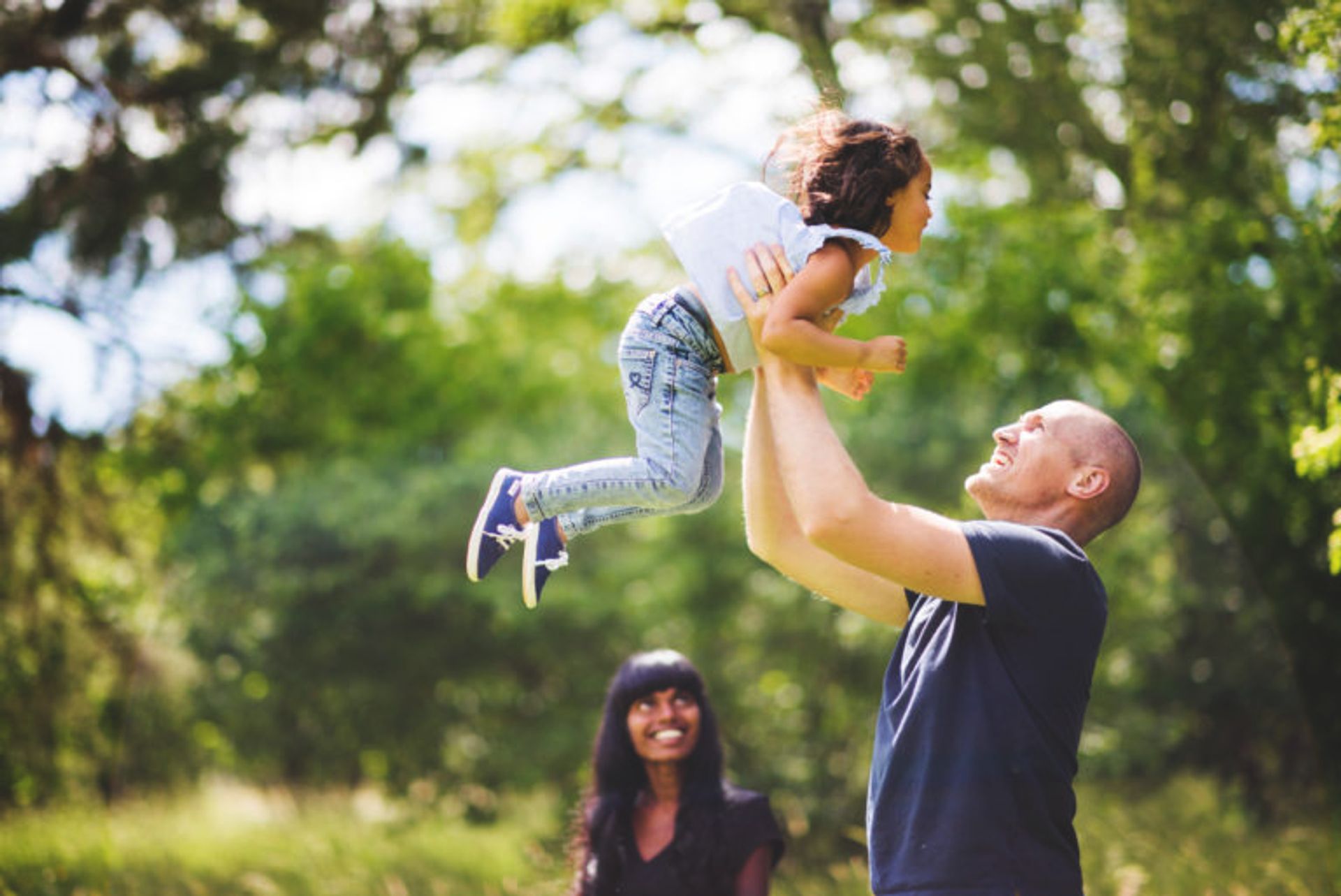 Family playing together in a park.