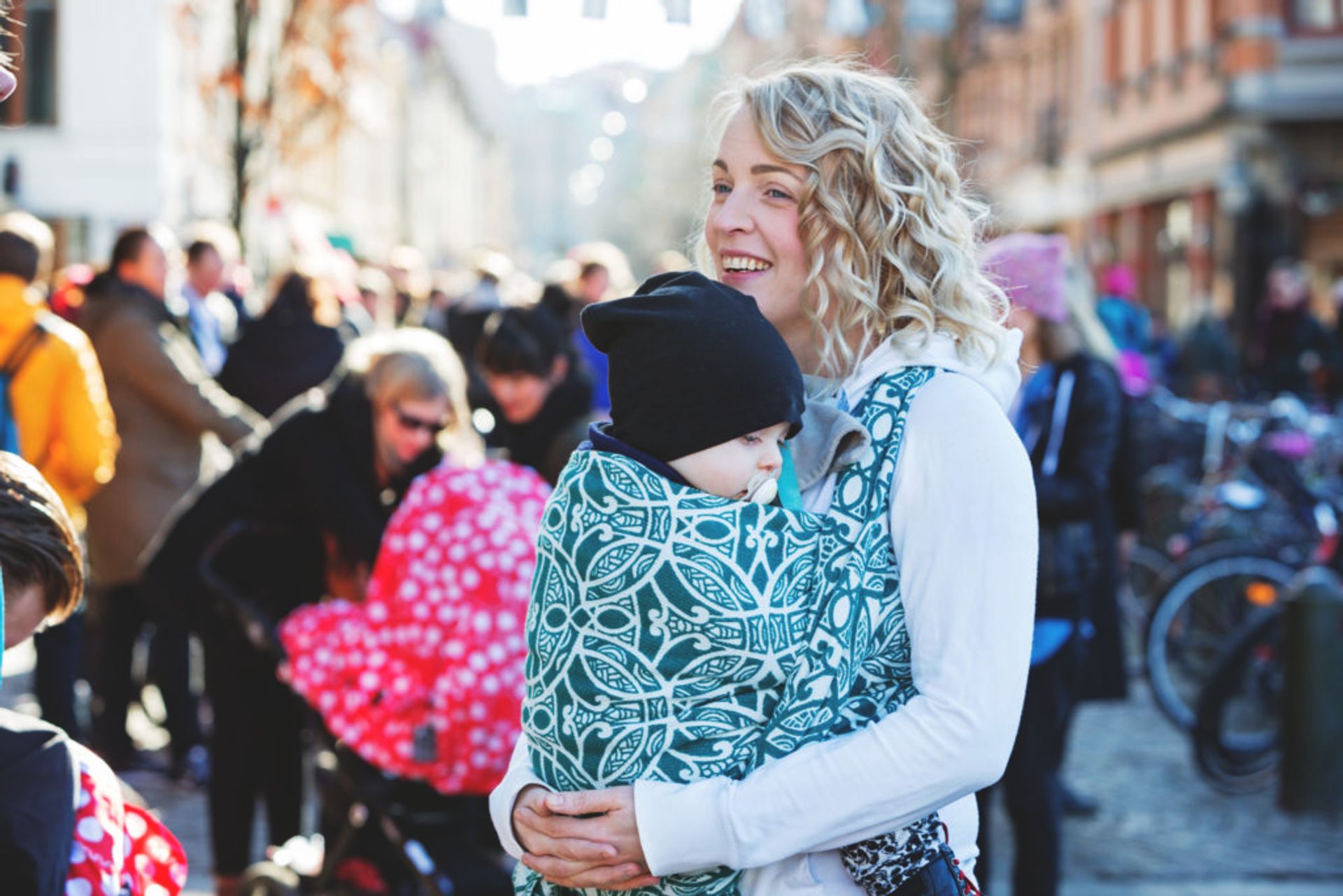 Woman carrying a baby in a baby sling.