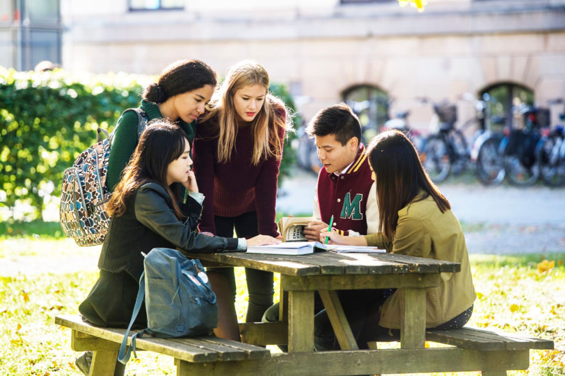 Students sitting at a bench.