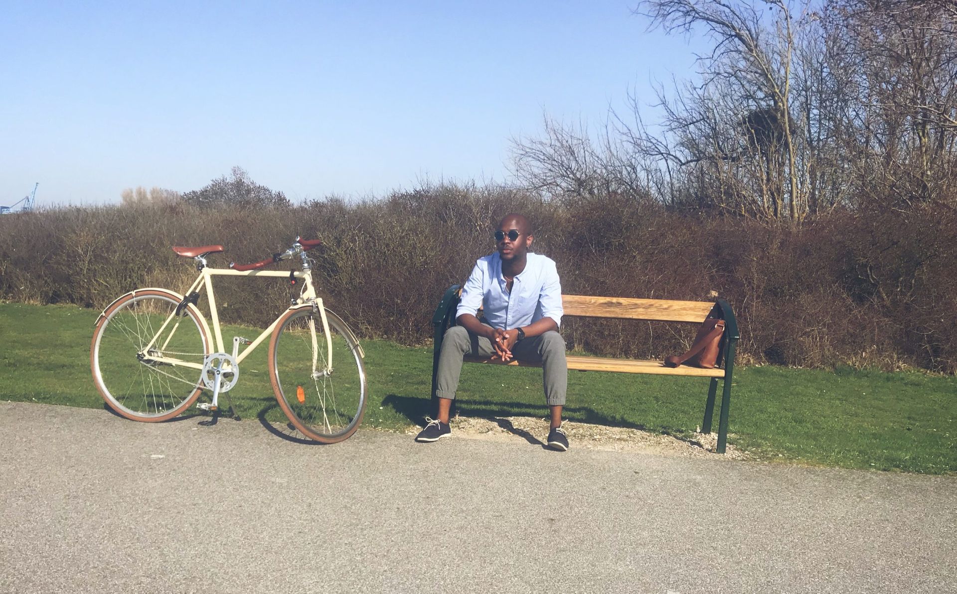 A photo of Sanjay relaxing with his bicycle