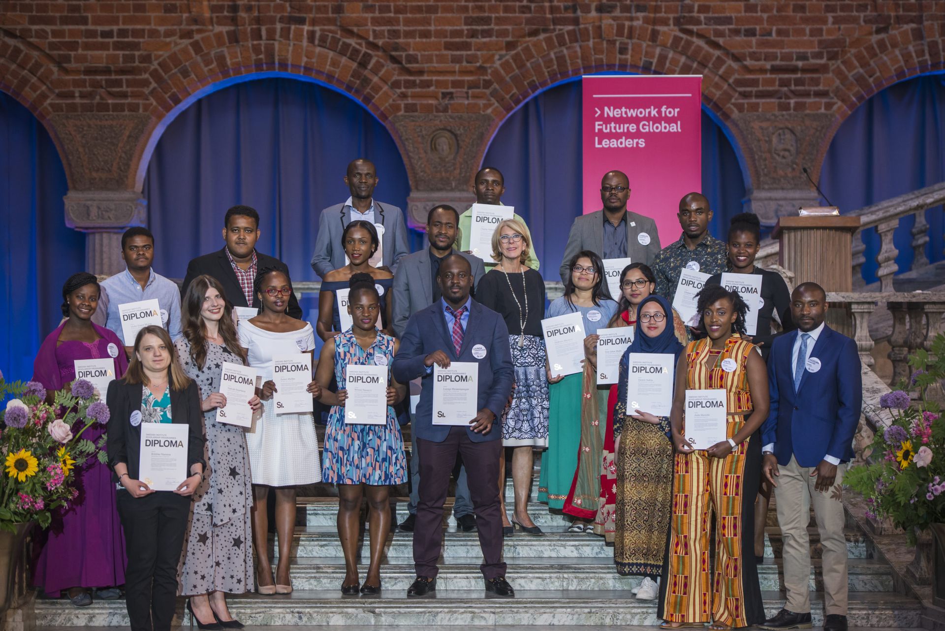 Swedish Institute scholarship recipients posing for a group photo at the graduation ceremony in Stockholm.