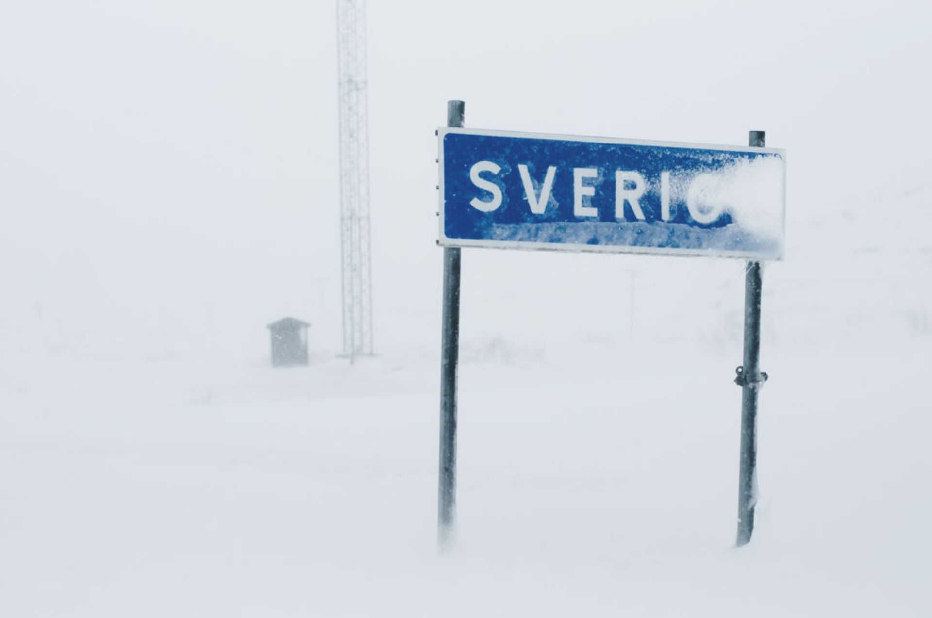 Snowy Sweden sign at the border.