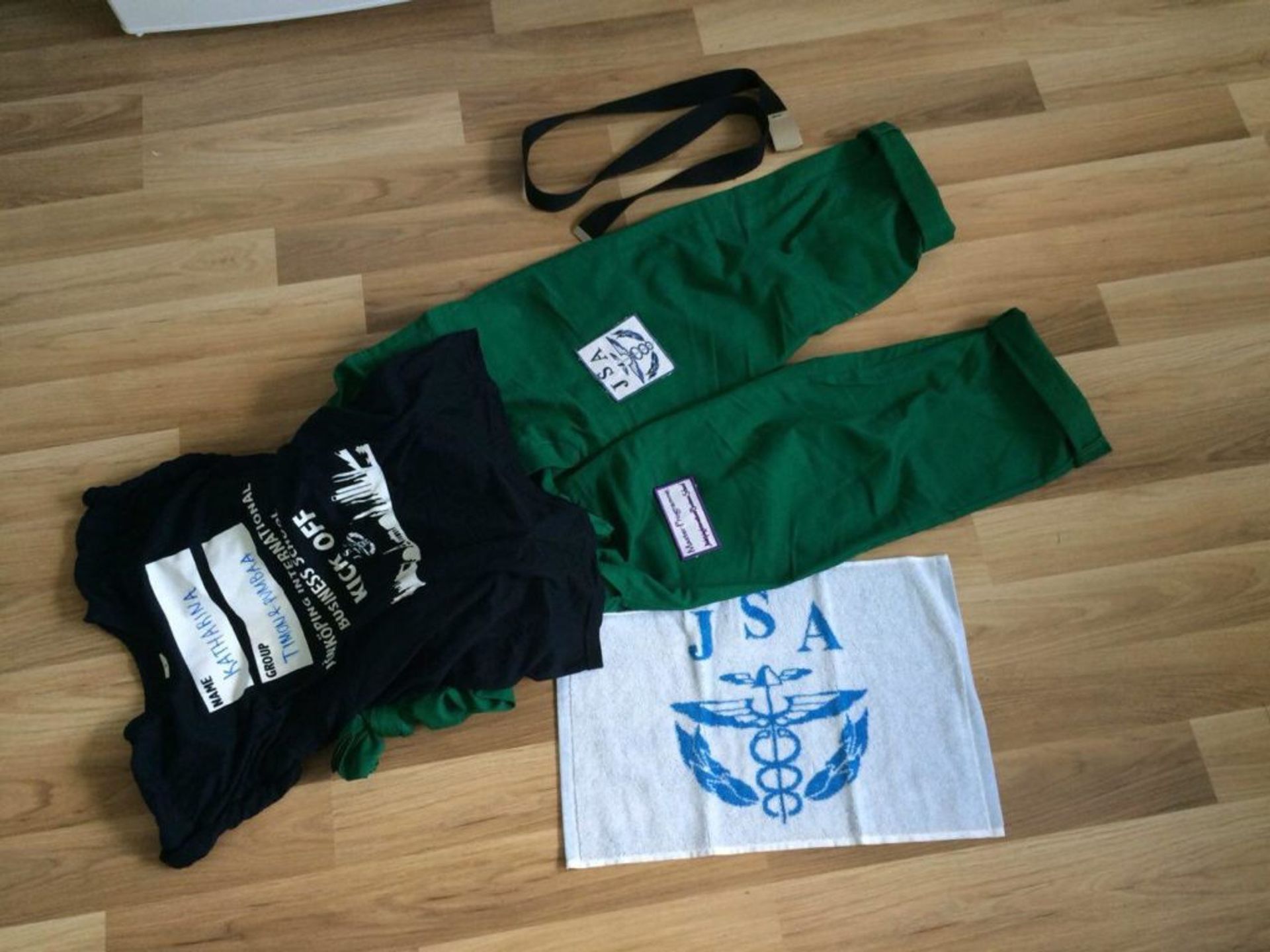 Green overall, t-shirt and towel.