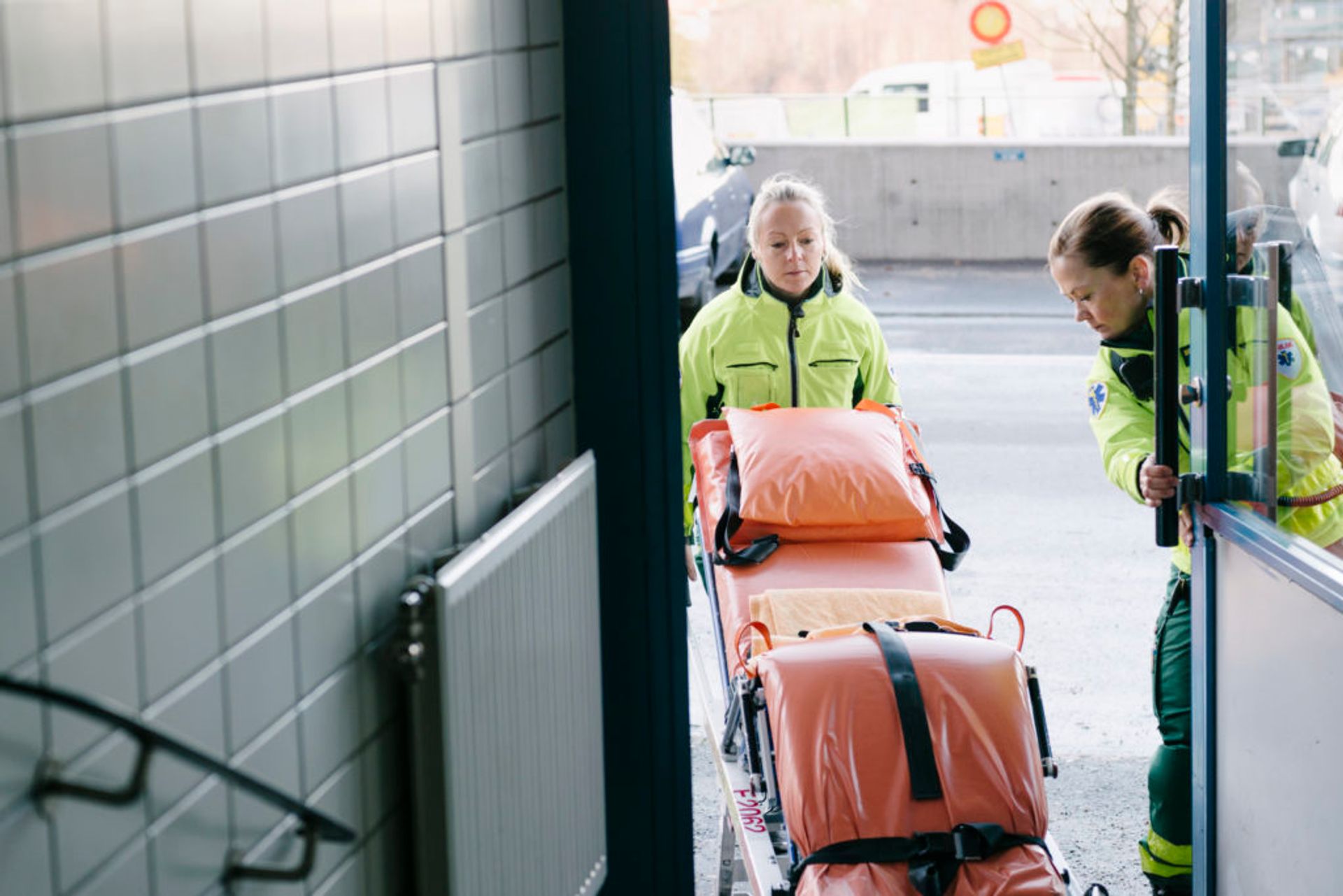 Ambulance staff going into a building.