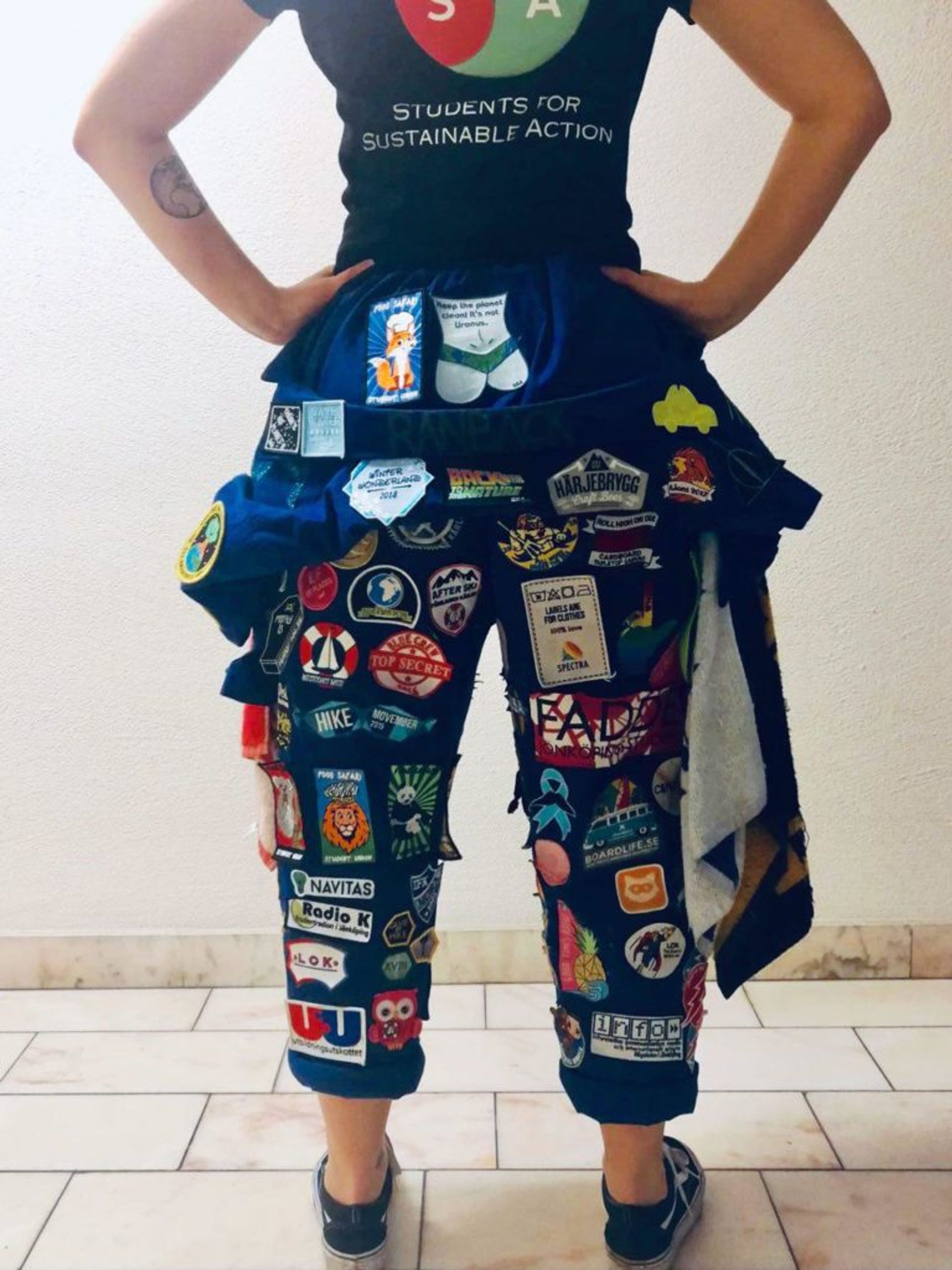 Student wearing an overall covered in patches.