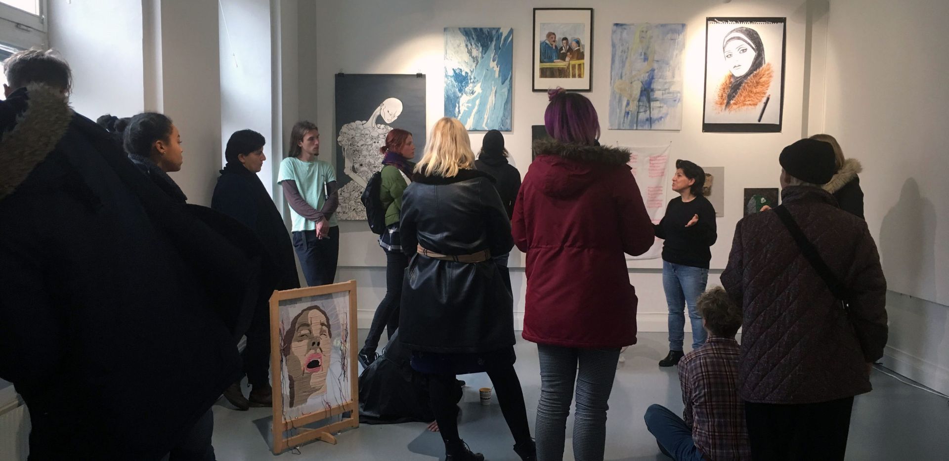 Students listening to an artist talk in a gallery space at Valand, University of Gothenburg