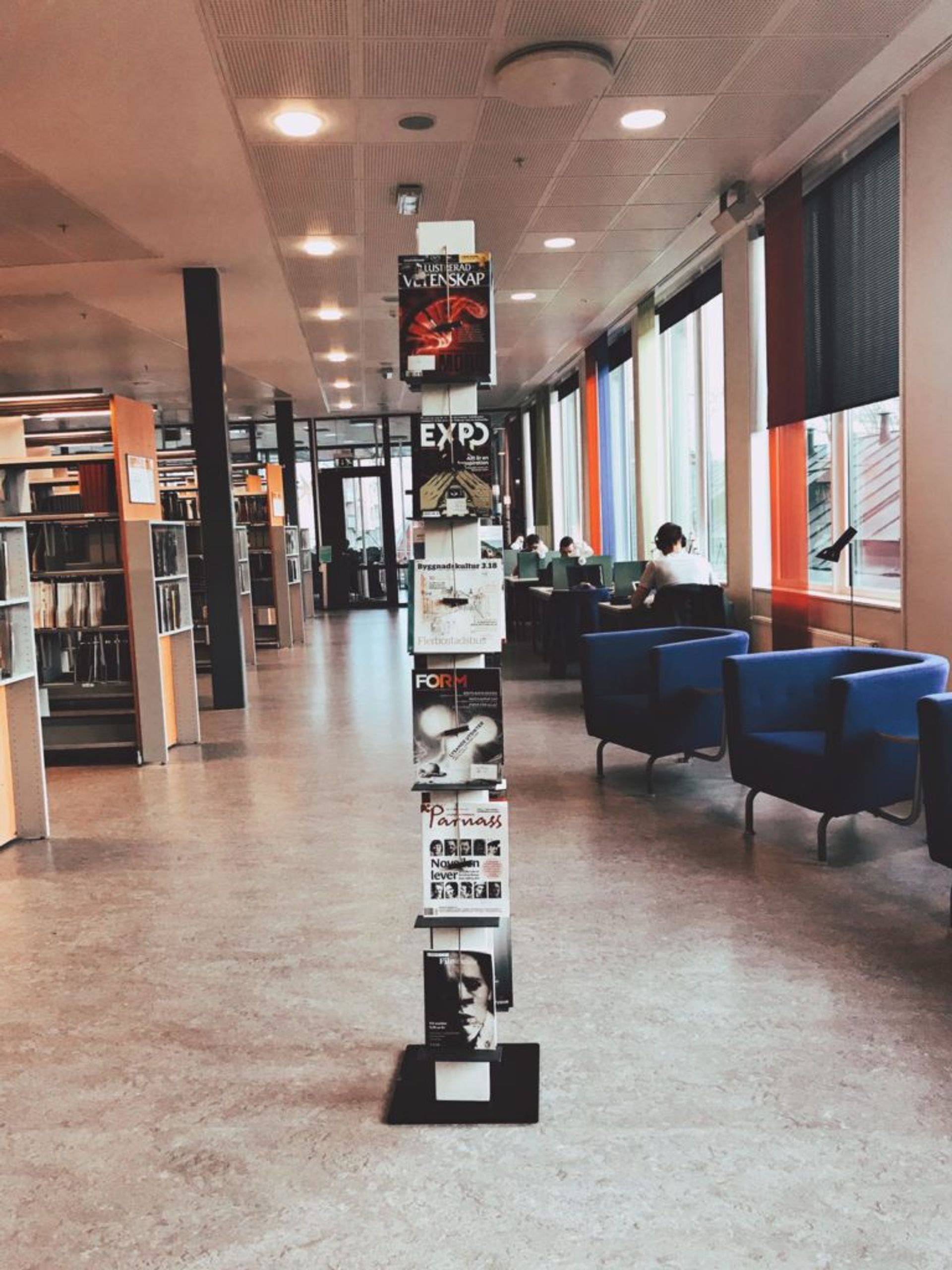 Magazine rack filled with design magazines in the middle of a university library.