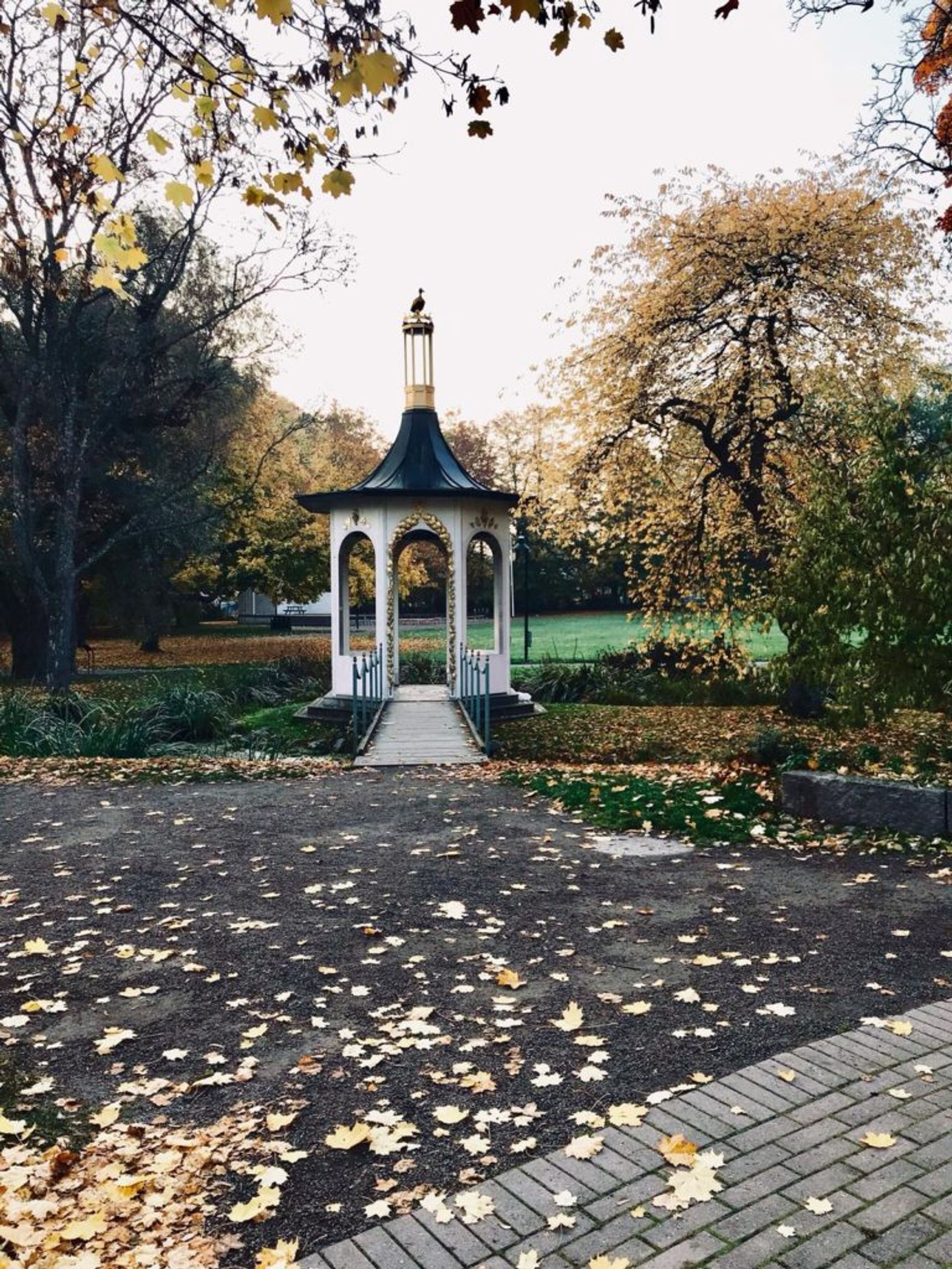 A white pagoda in a park.