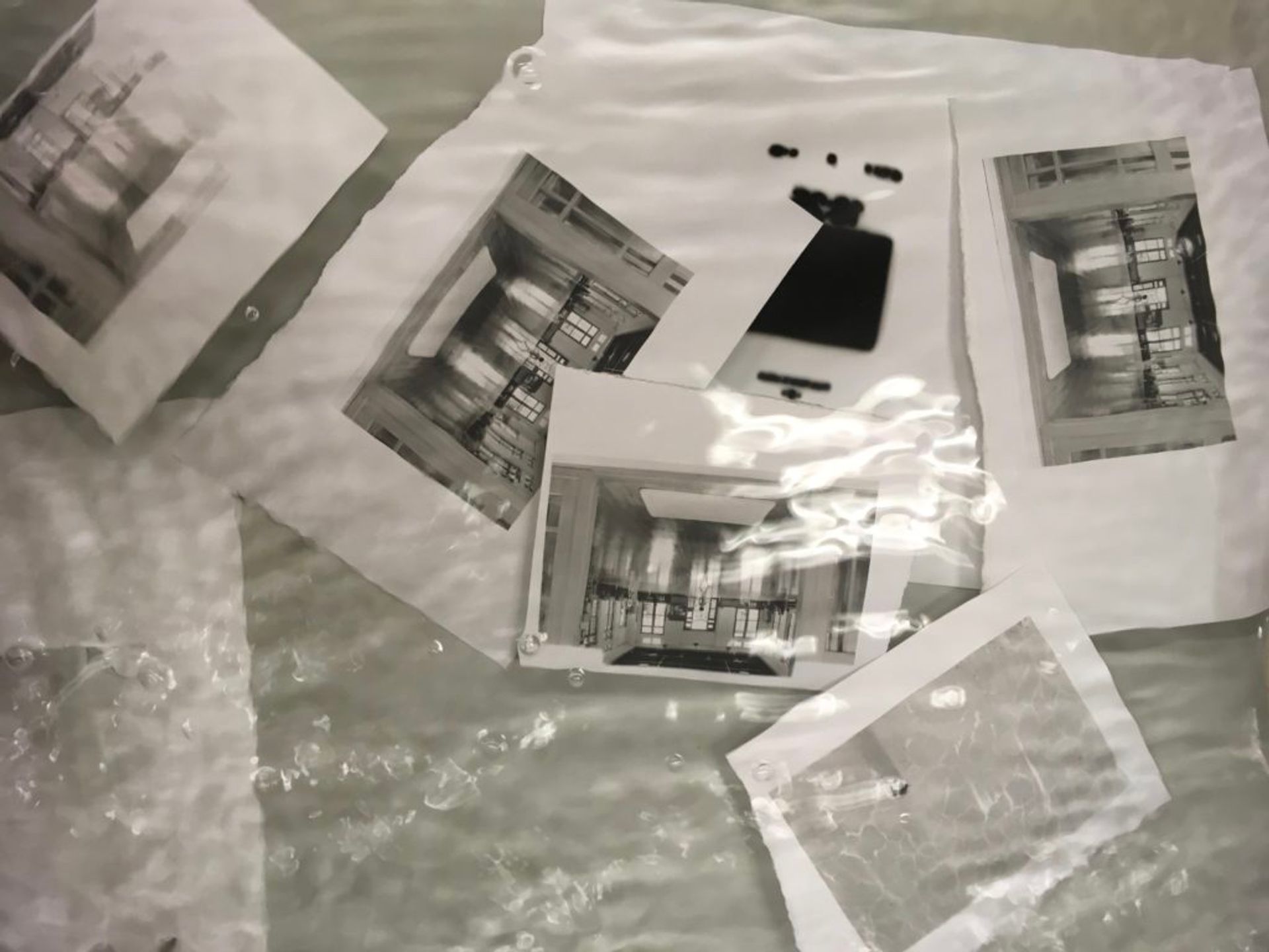 Washing chemicals off black and white prints in the darkroom.