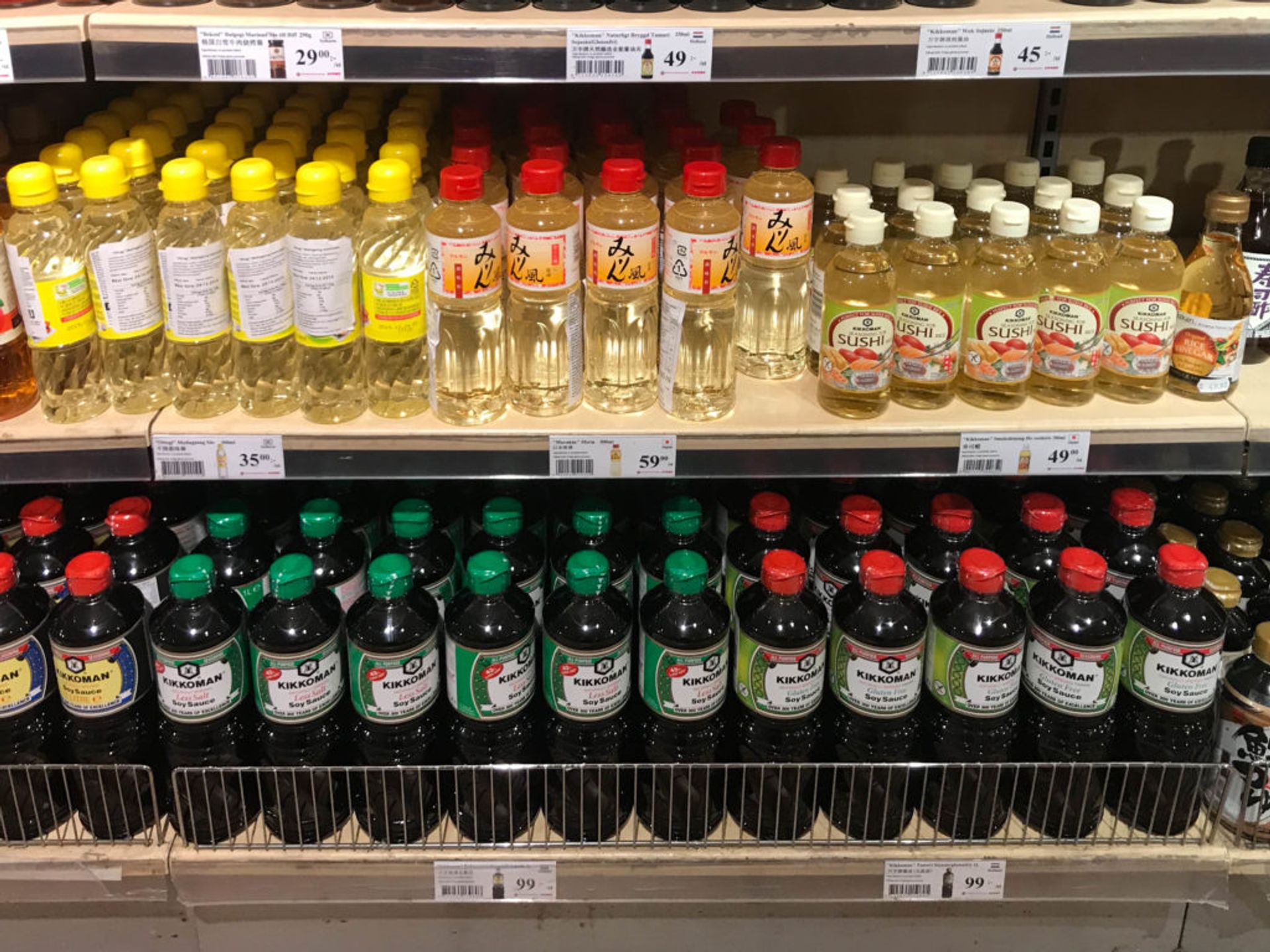 Shelves of chilled sauce bottles.