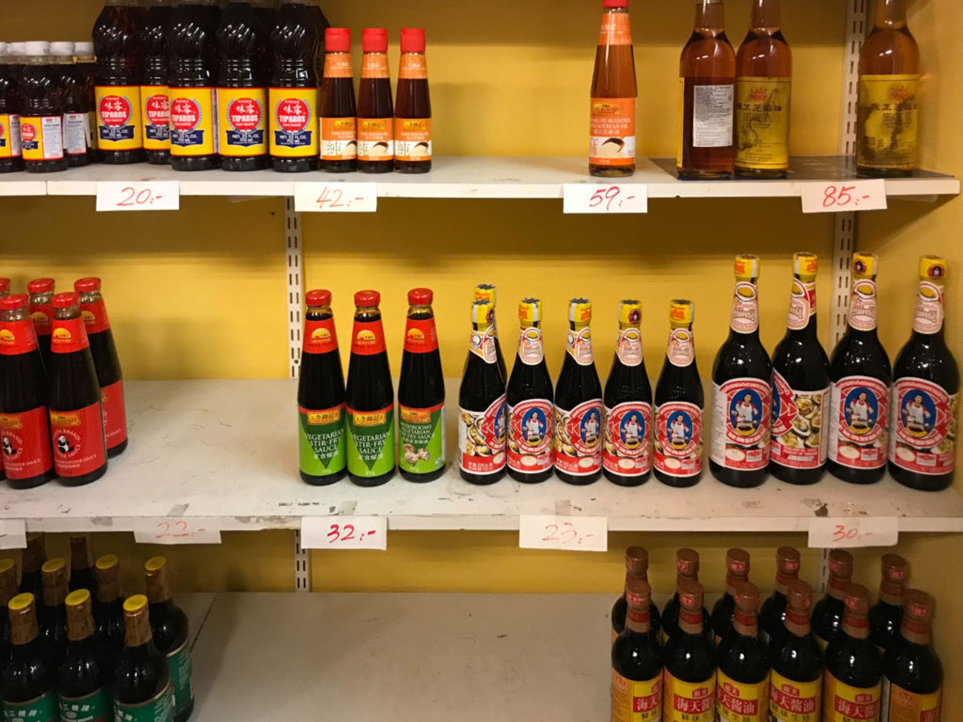 Shelves of sauce bottles.