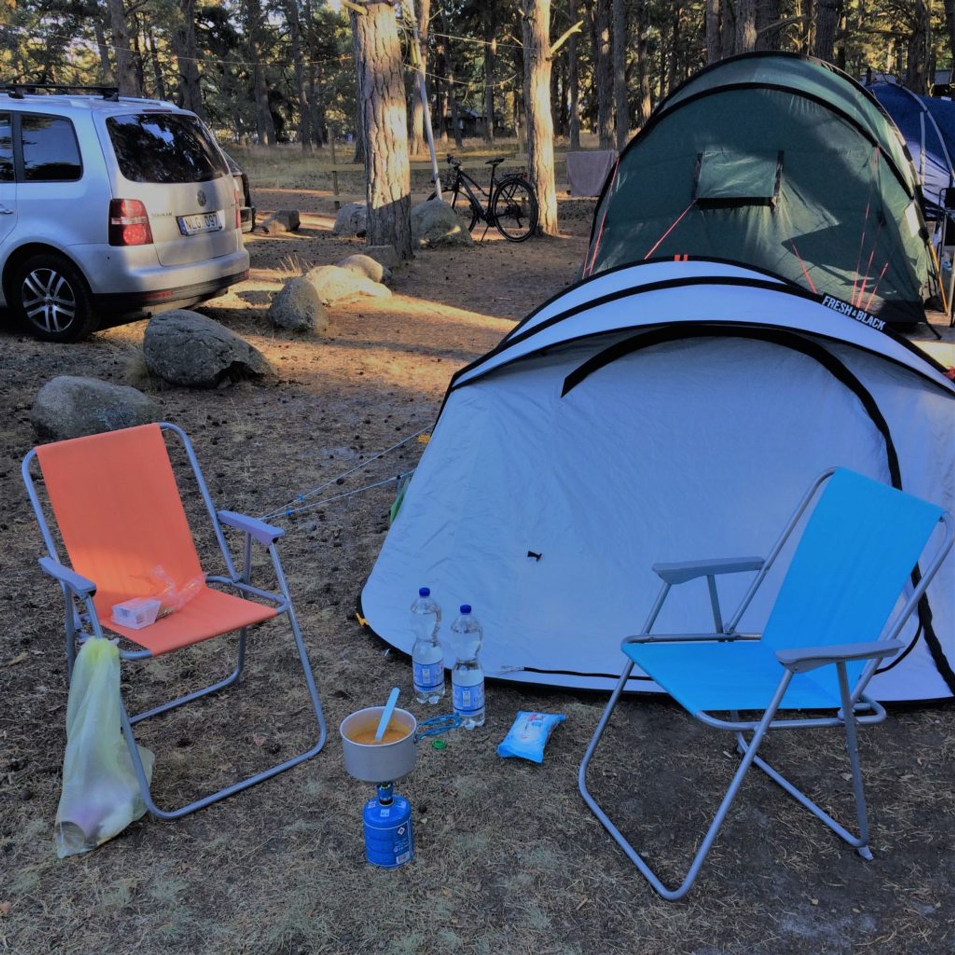 Tent and chair on a camping spot.