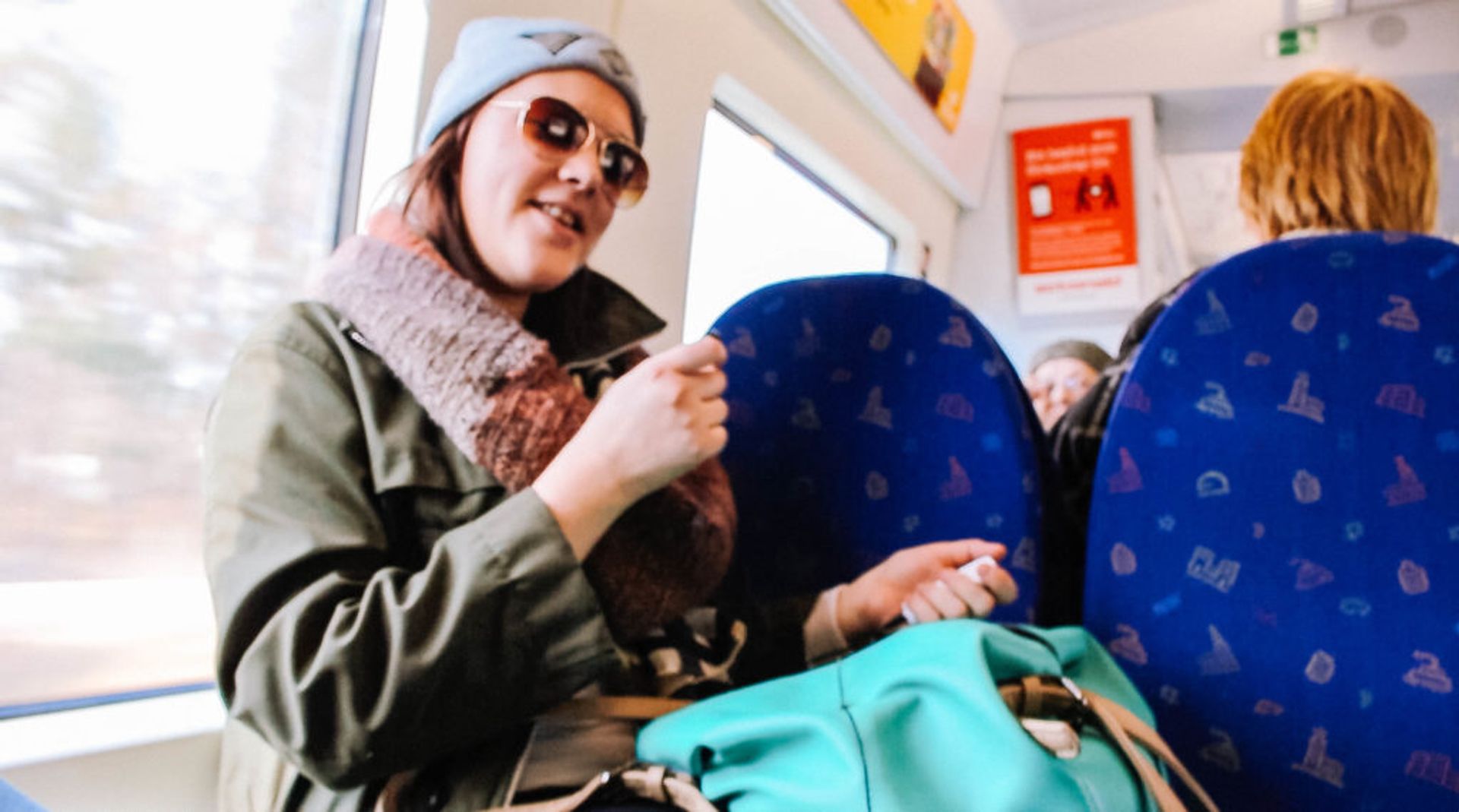 Person sitting on a commuter train.