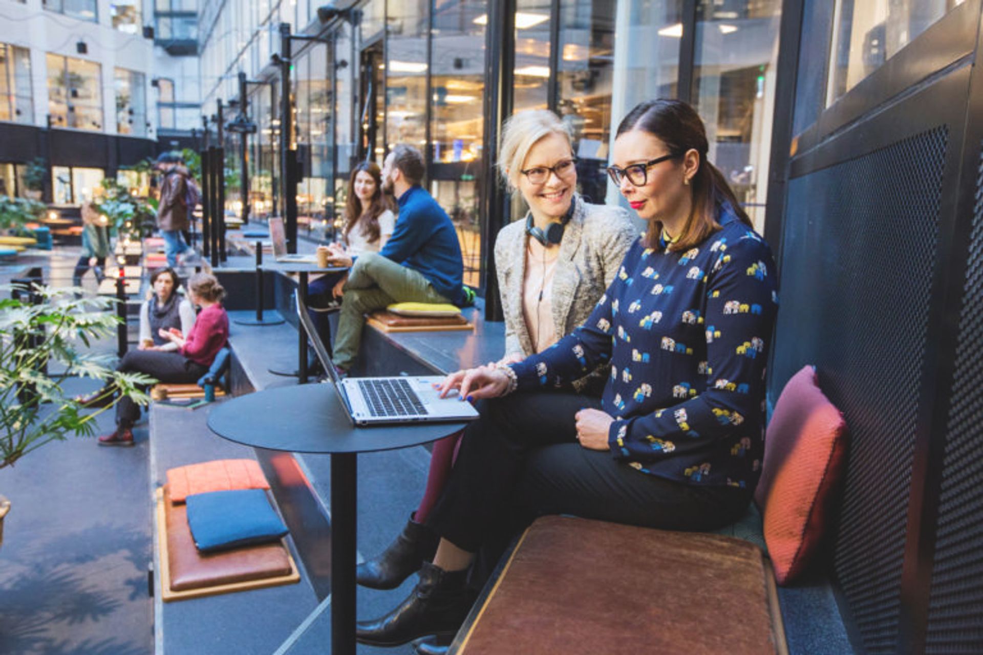 Two people looking at a laptop.