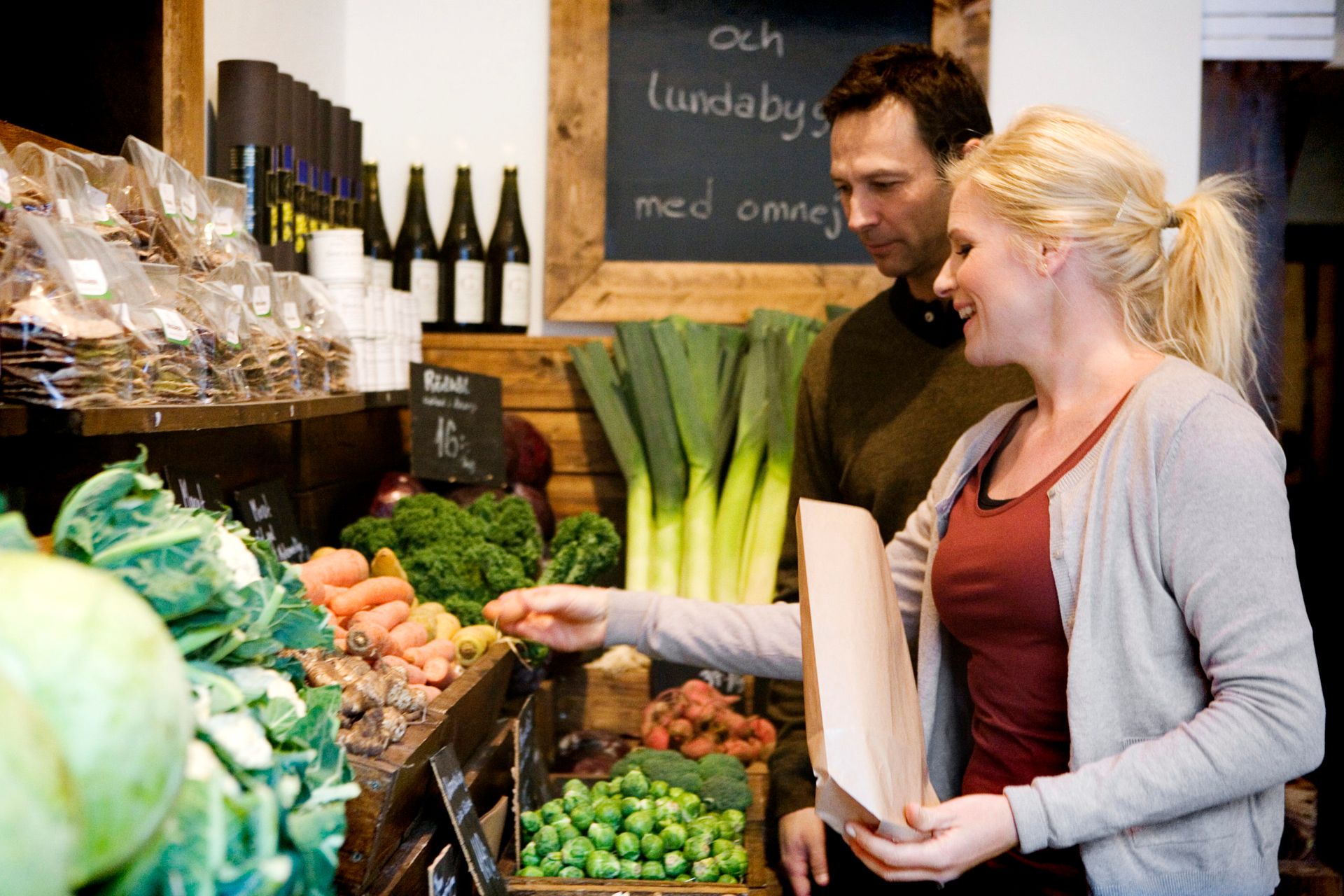 Two people shopping for vegetables.