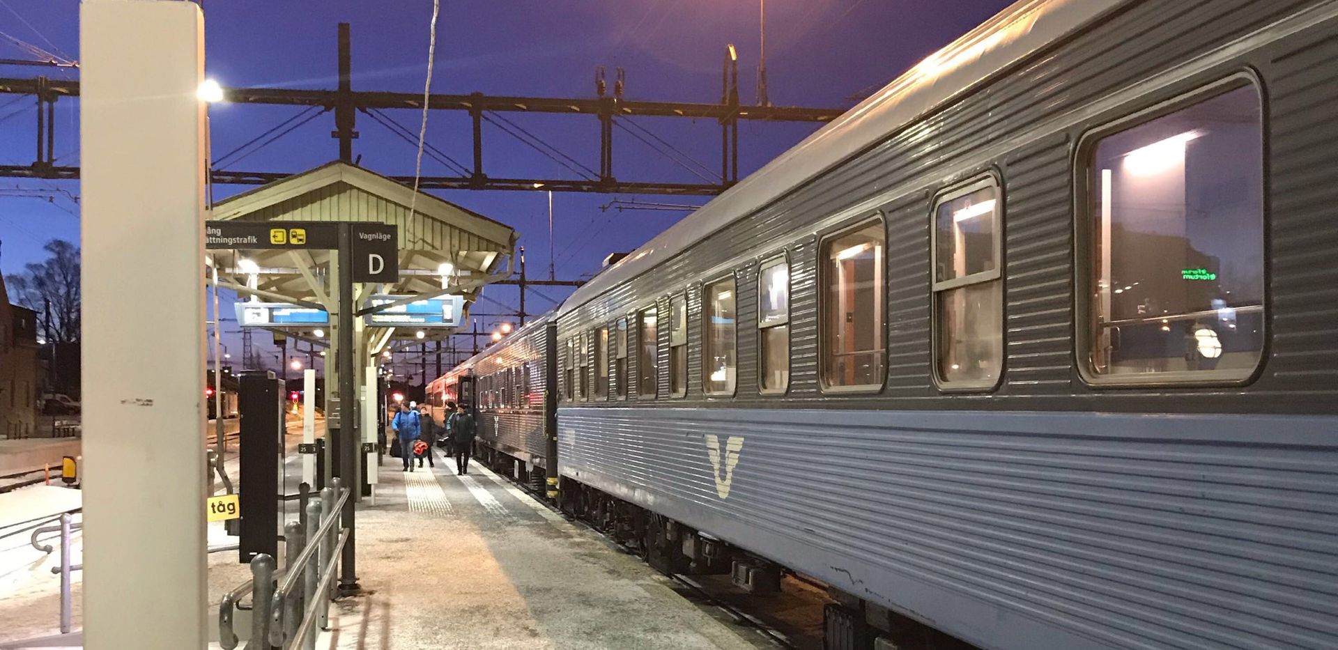 A sleeper train at a train station.