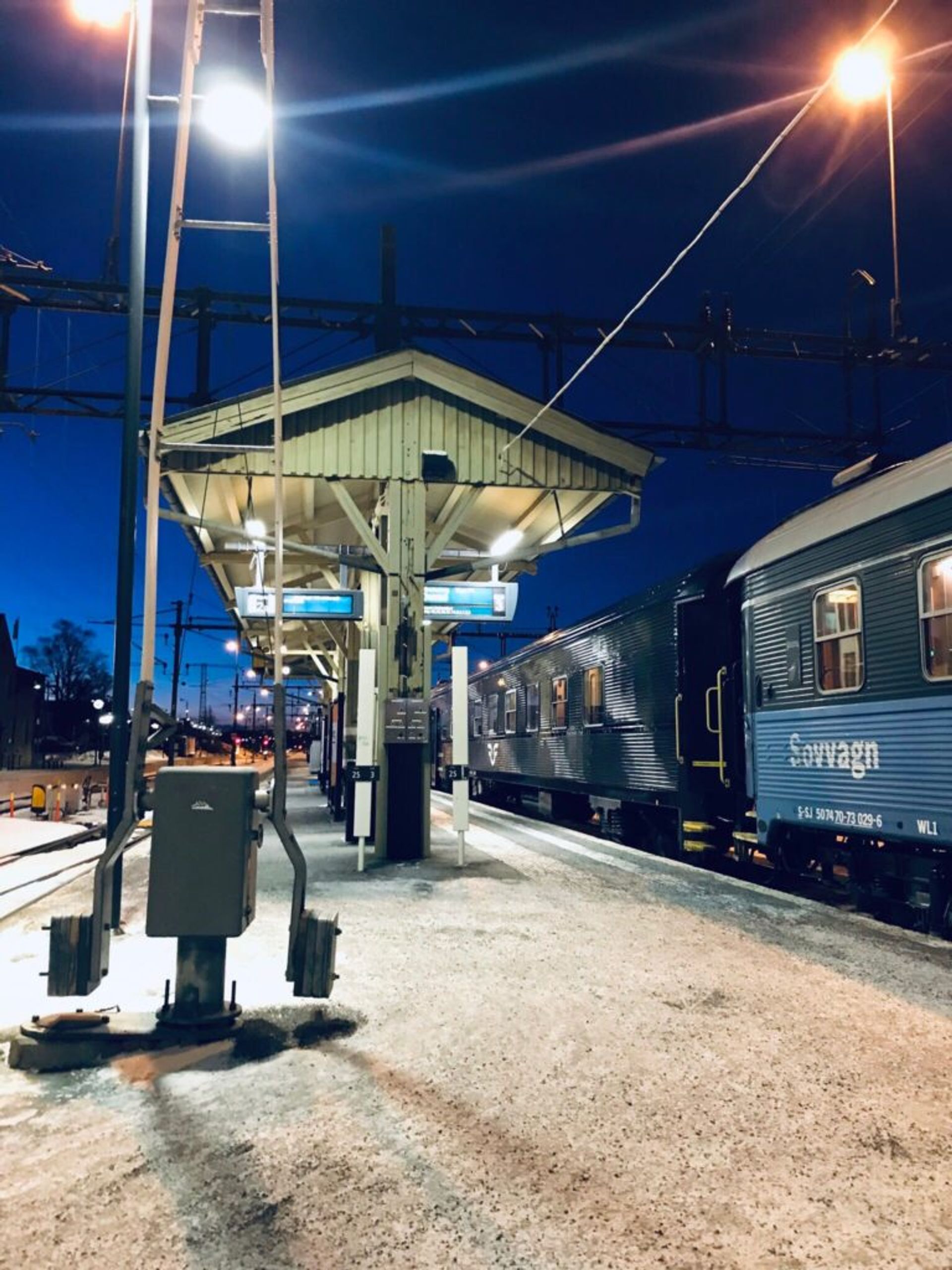 A sleeper train at a train station.