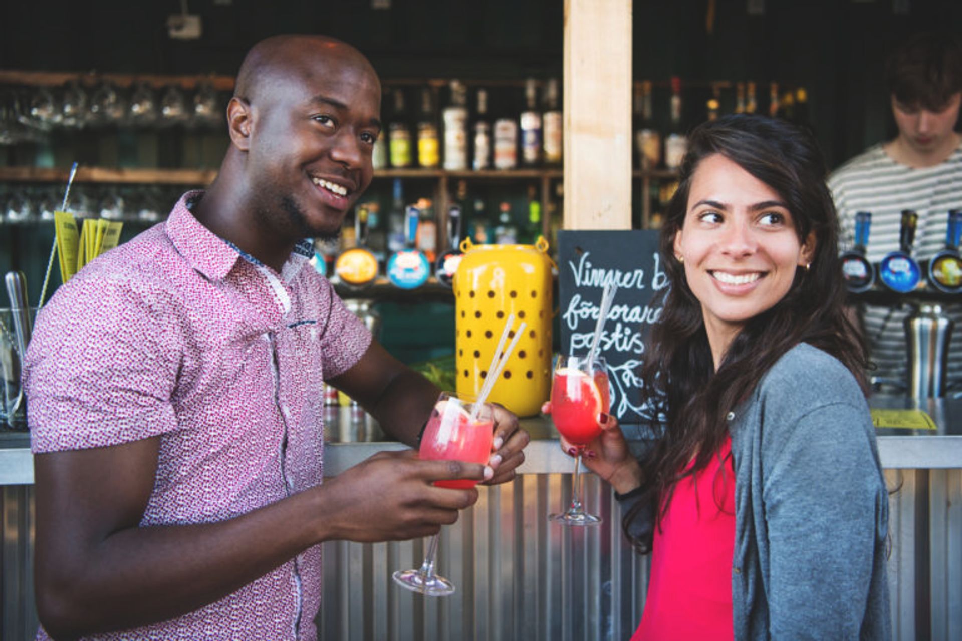 A man and a women having drinks in a bar. 