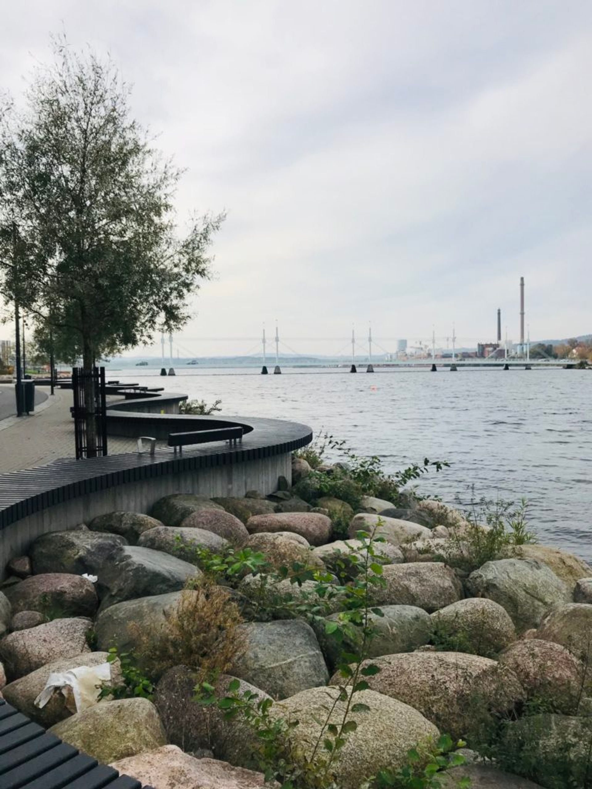 Wooden benches by a lake.