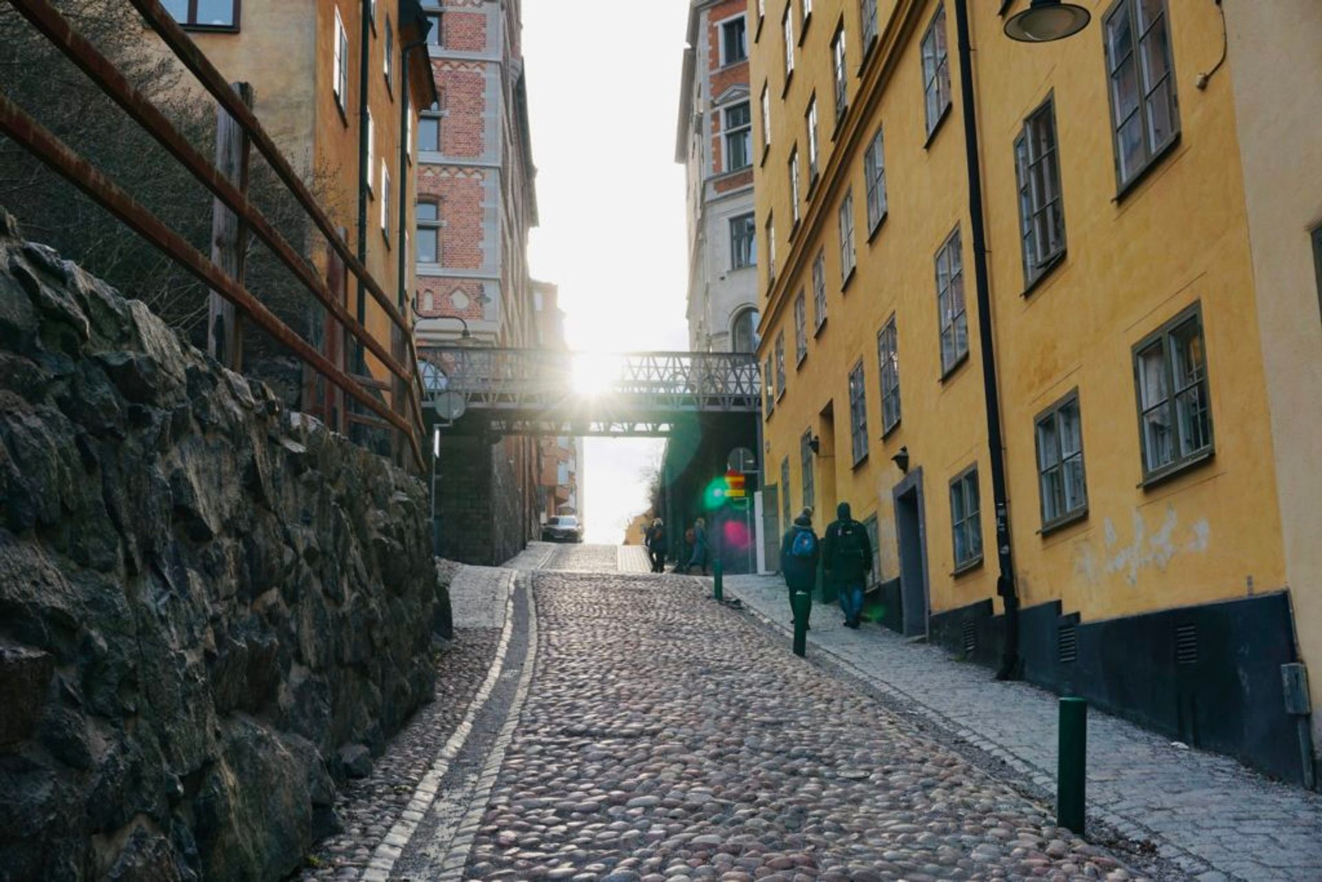 People walking along a cobbled stree.