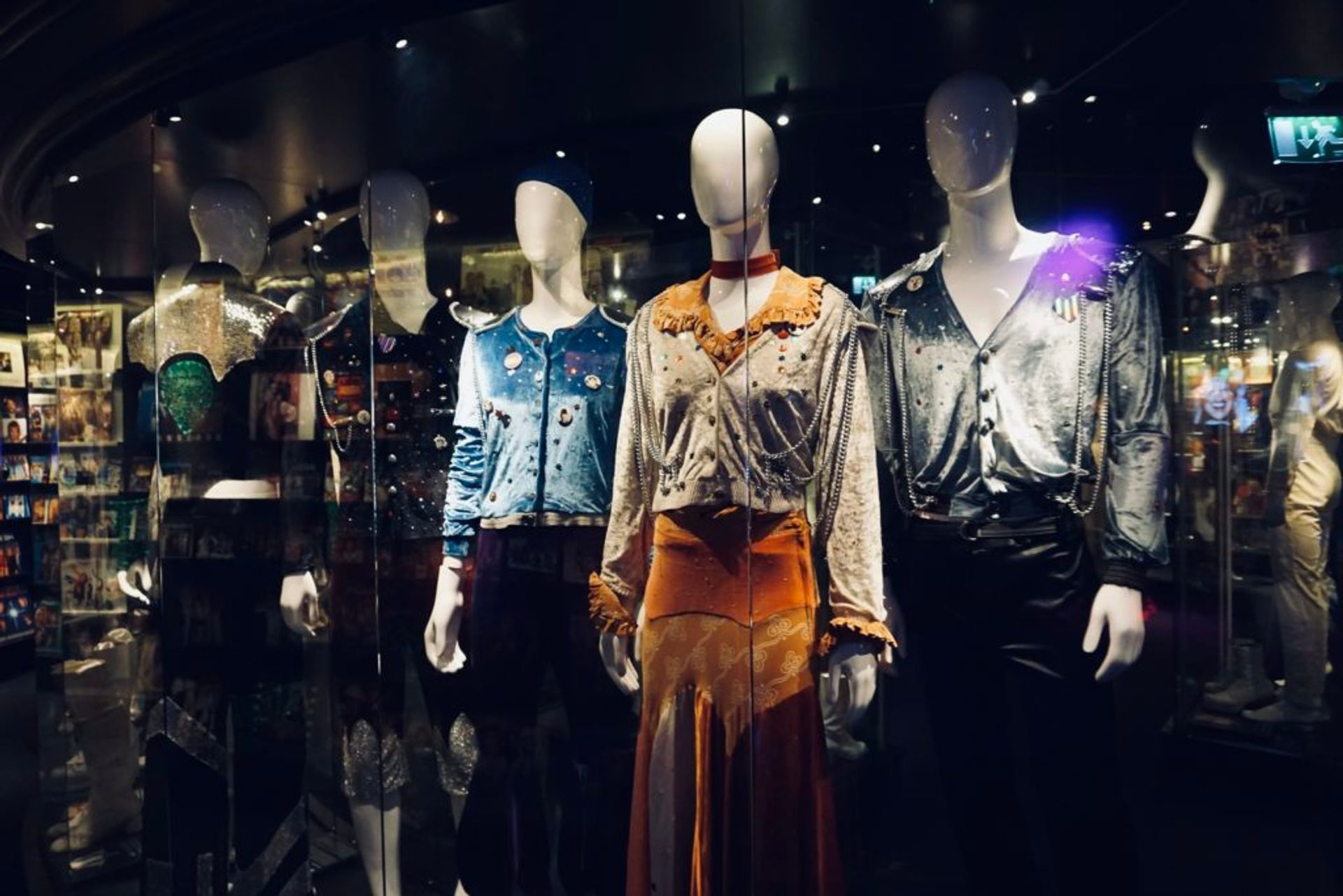 ABBA costumes in a exhibition cabinet.