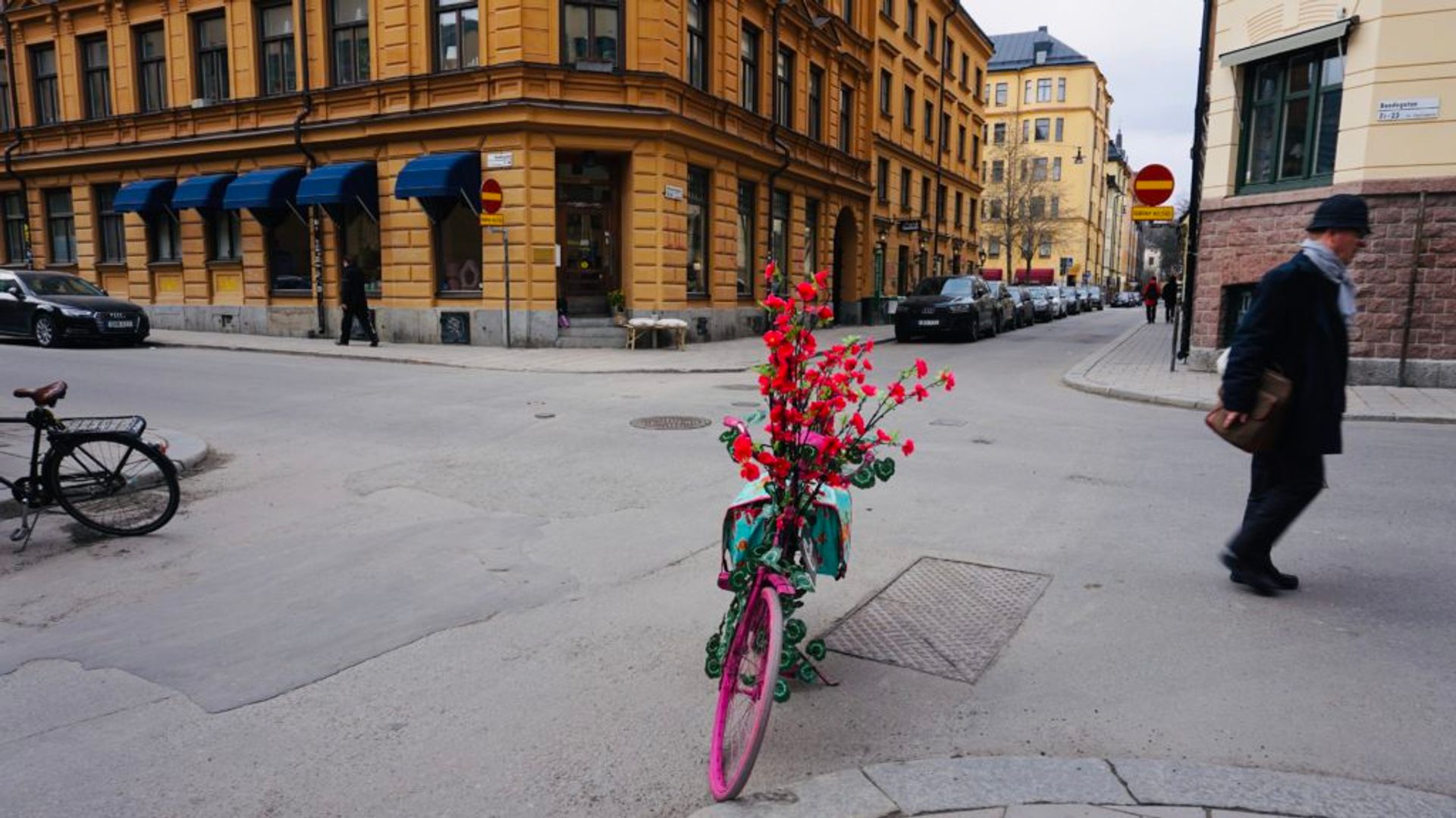 A pink bicycle parked outside a store.