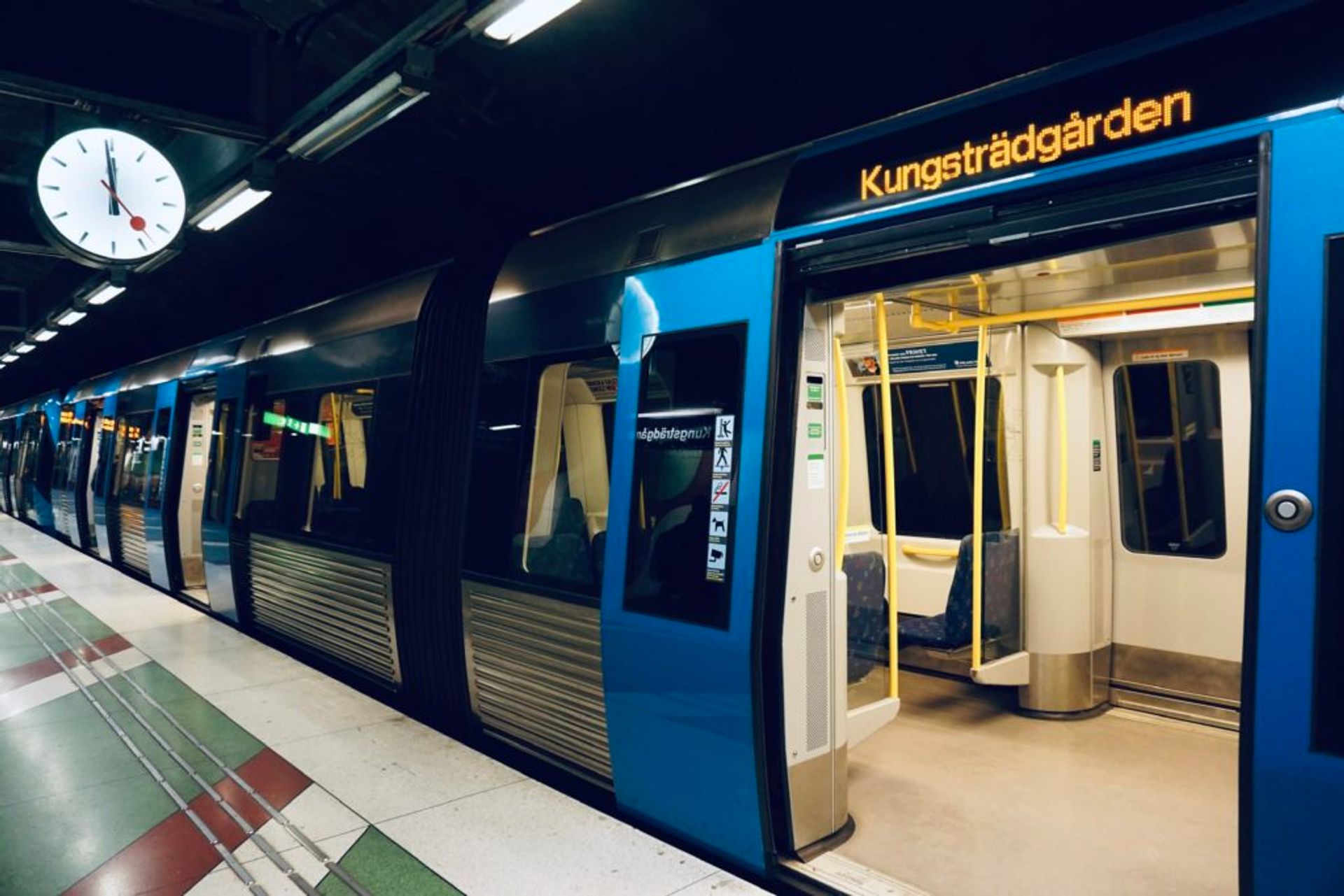 New, blue metro trains at a metro station.