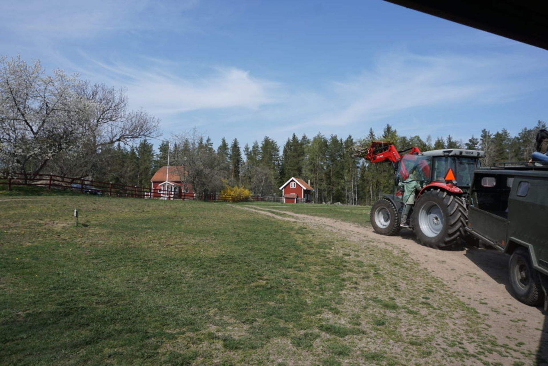 A person climbing into a tractor.