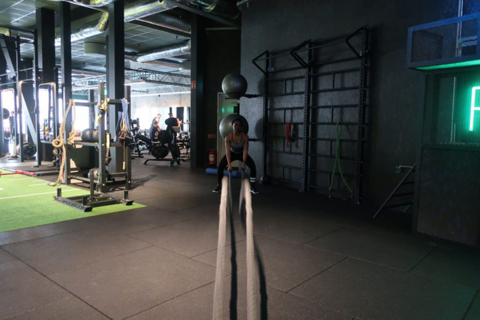 A woman at a gym working out. 