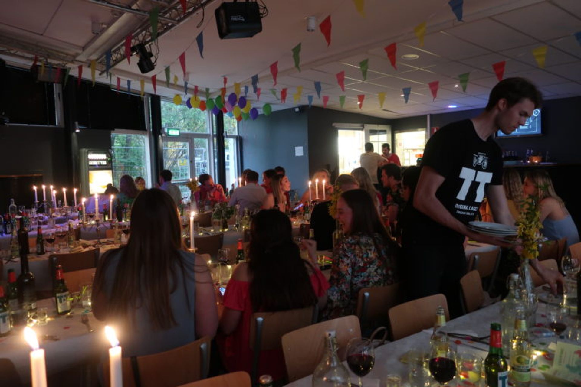 Students having dinner in a big hall.