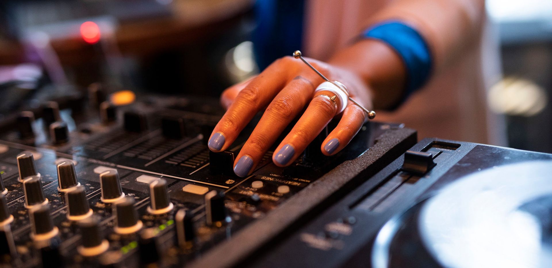 Close-up of a hand on a music controller.