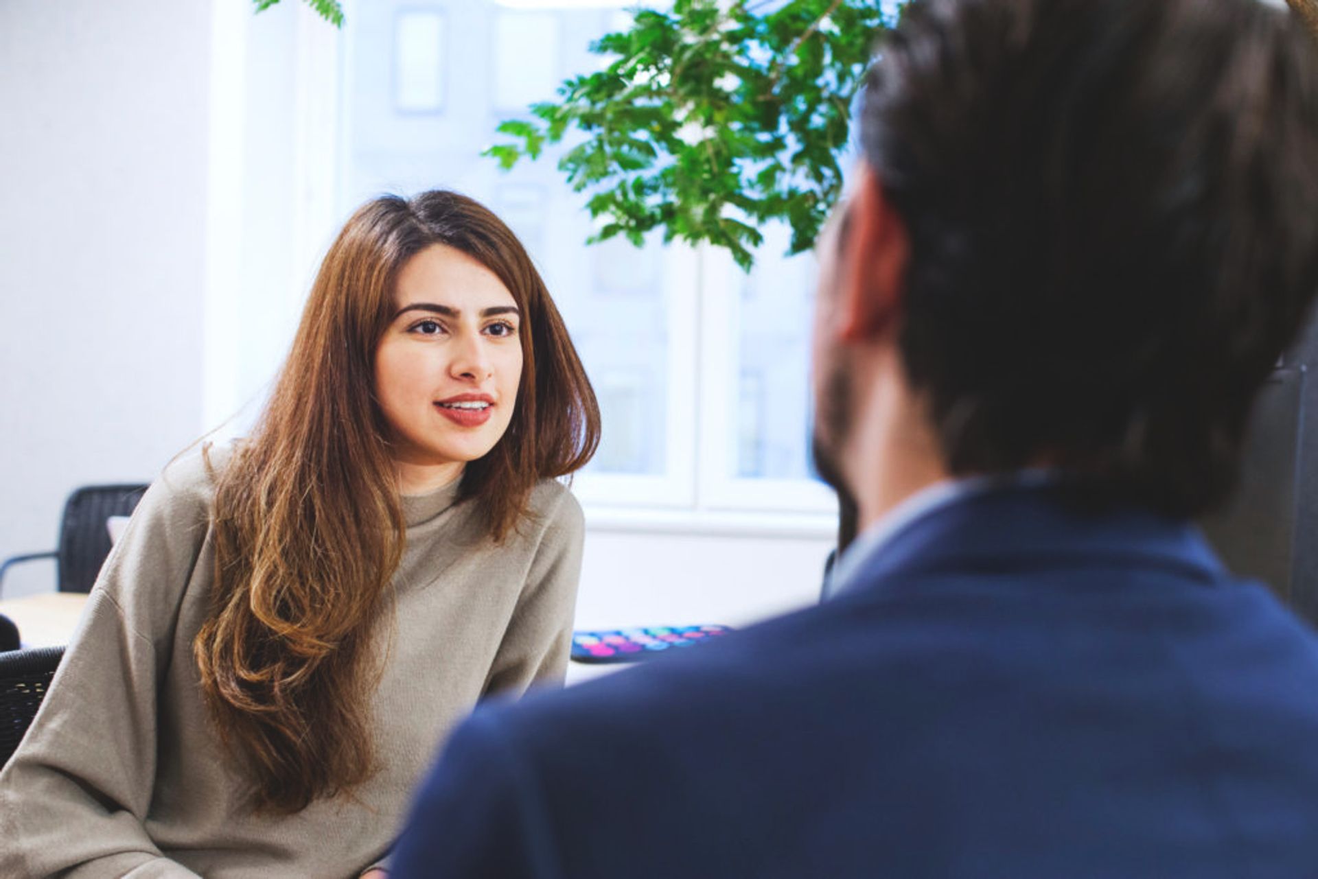 Two people talking in an office.