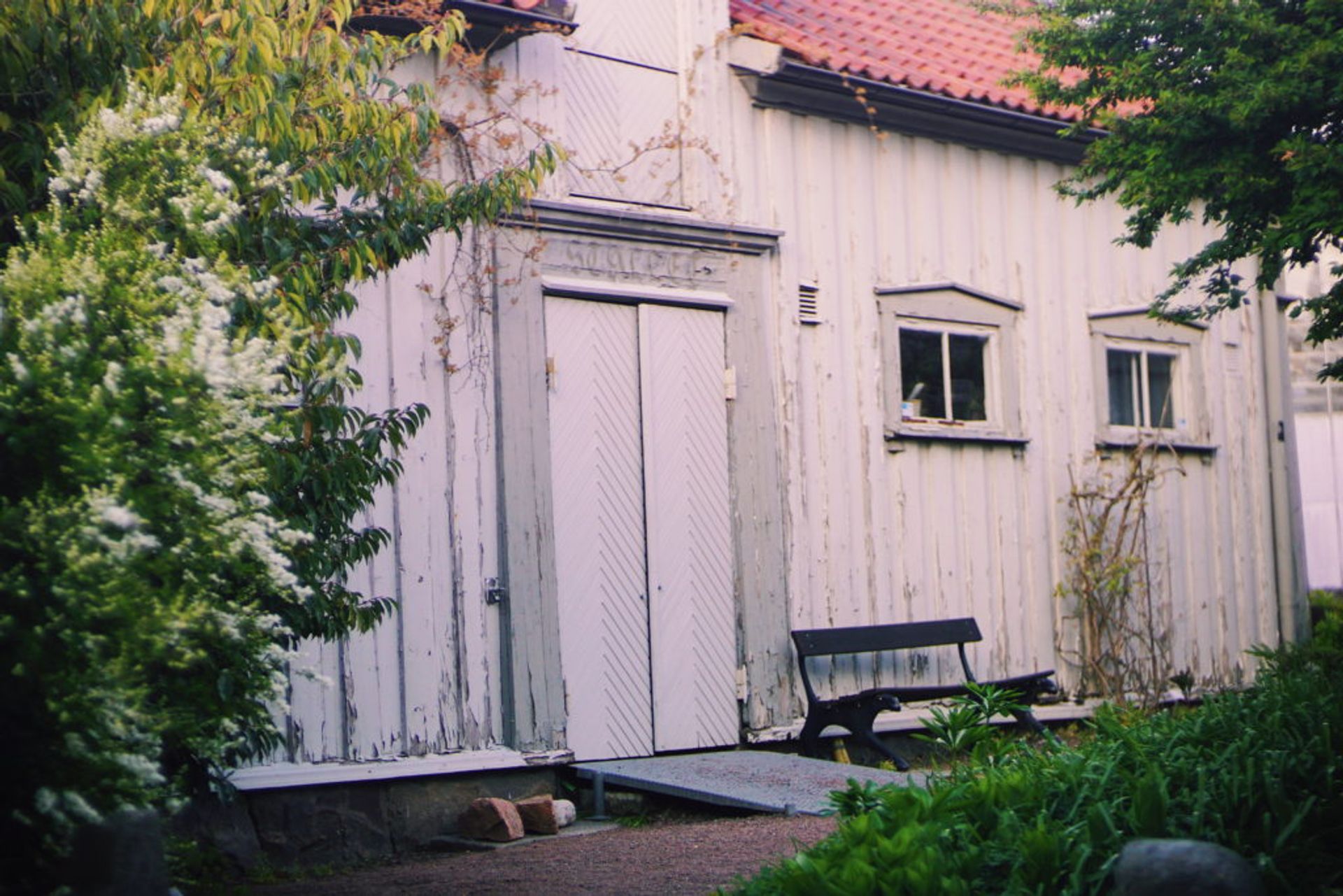 A white, wooden building in the park.