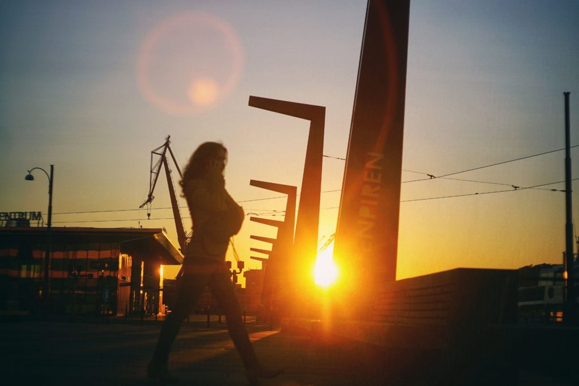 A person walking beside the harbour.