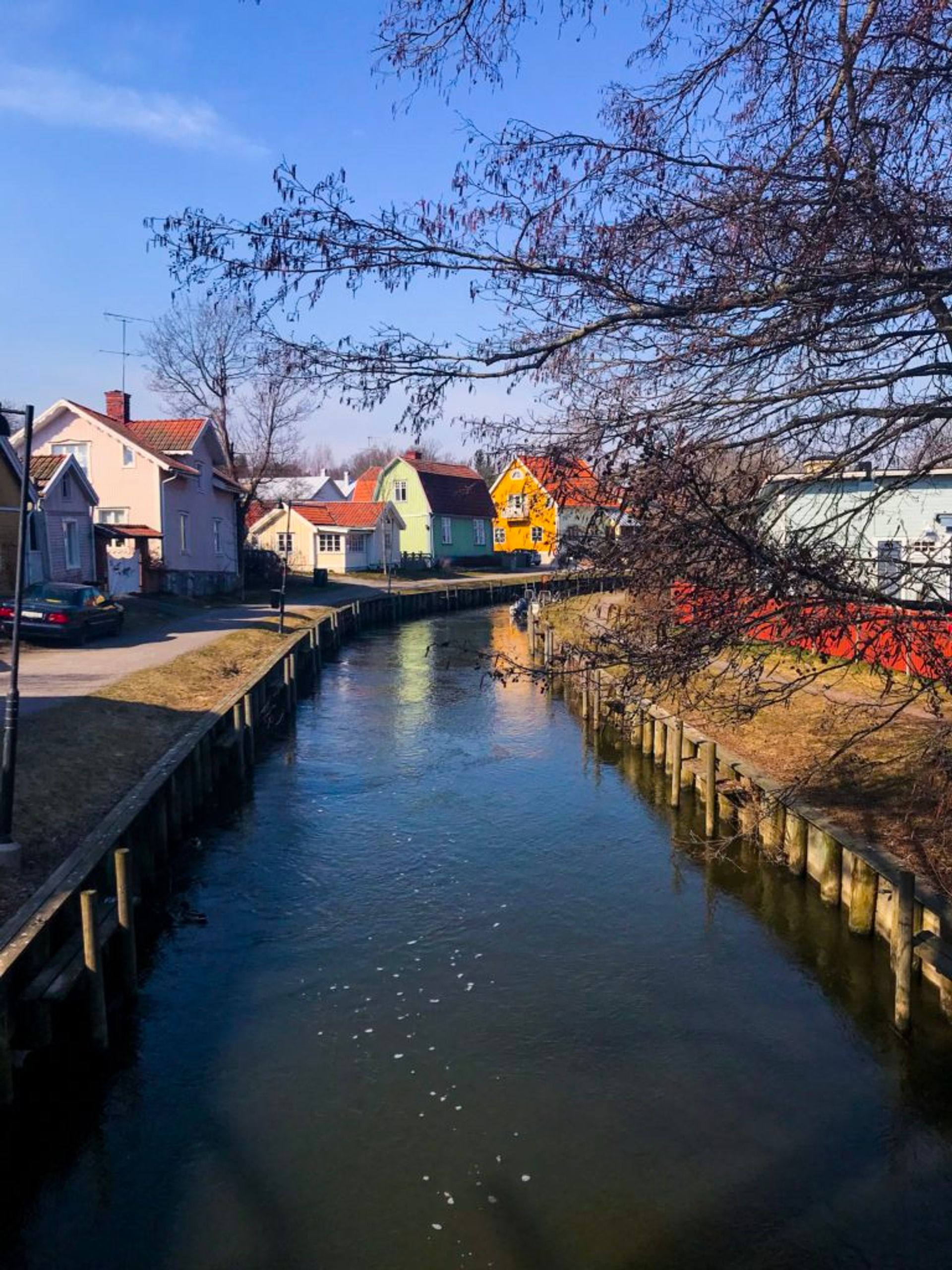 Colourful buildings beside a river.